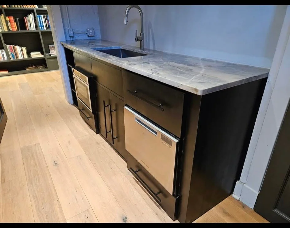 Alternate angle of the custom industrial utility counter and kitchenette. This detail view showcases the precision-welded steel cabinetry and the flush, seamless integration of the under-counter appliances. Built with heavy-gauge materials to provide