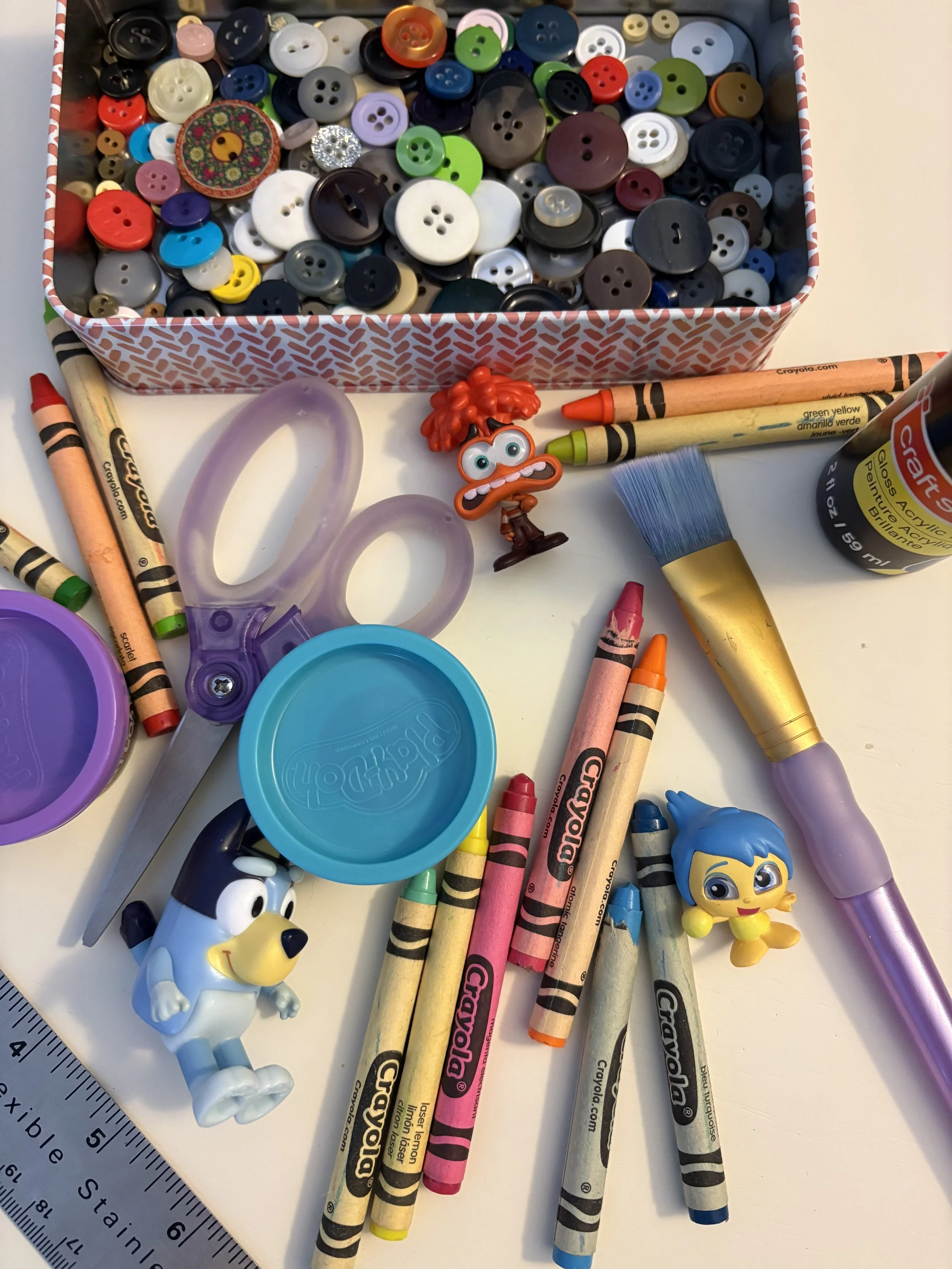 Buttons, crayons, playdoh, cartoon figurines