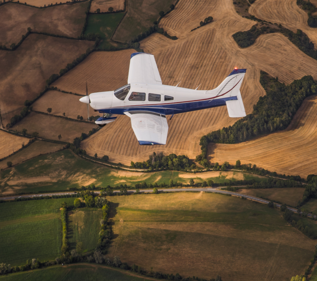 photo from uAvionix, general aviation aircraft flying over green and brown fields