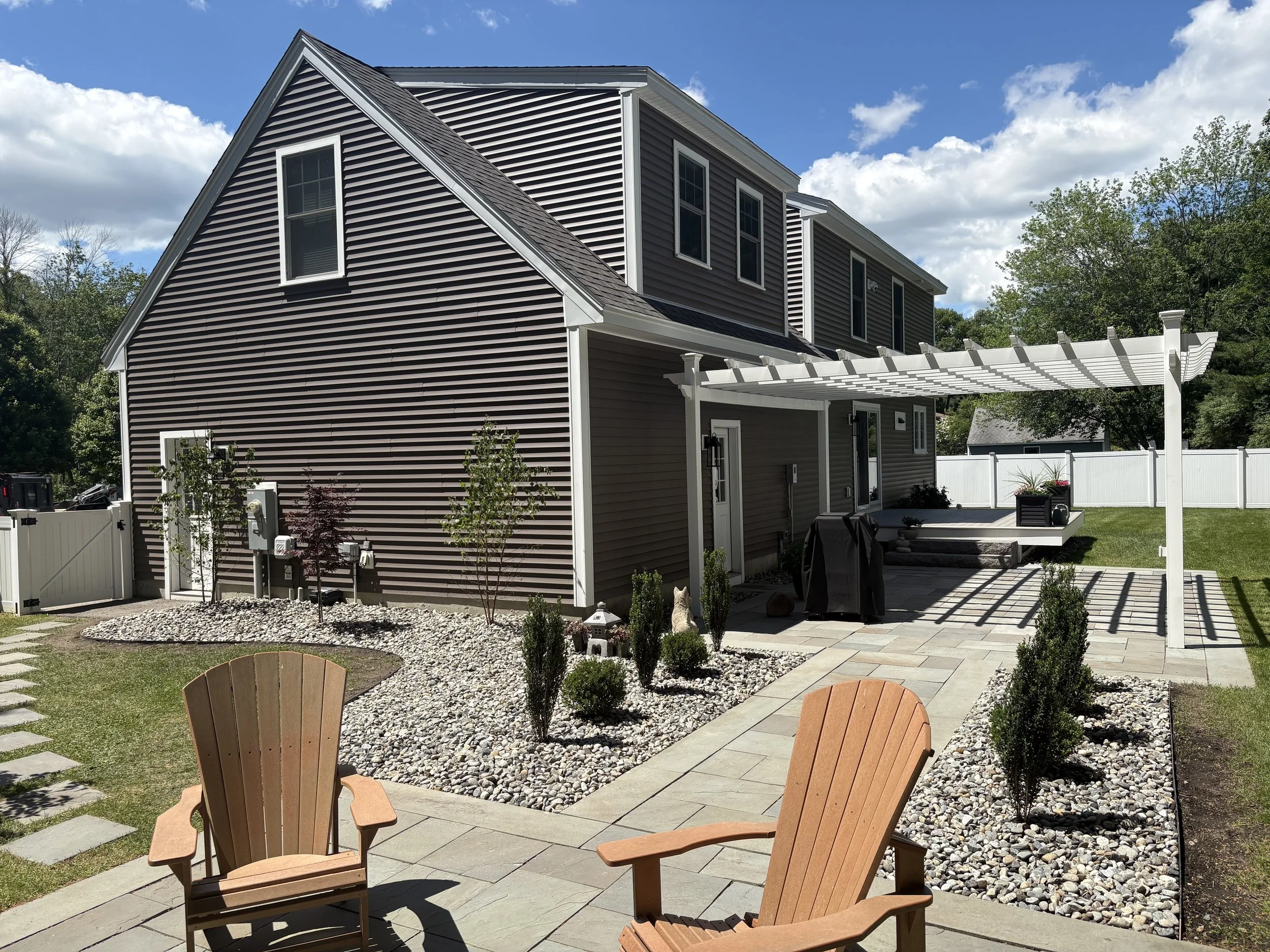 New plantings and decorative 1.5-inch round stone installed by O'Neill Landscaping in Greenland, NH.