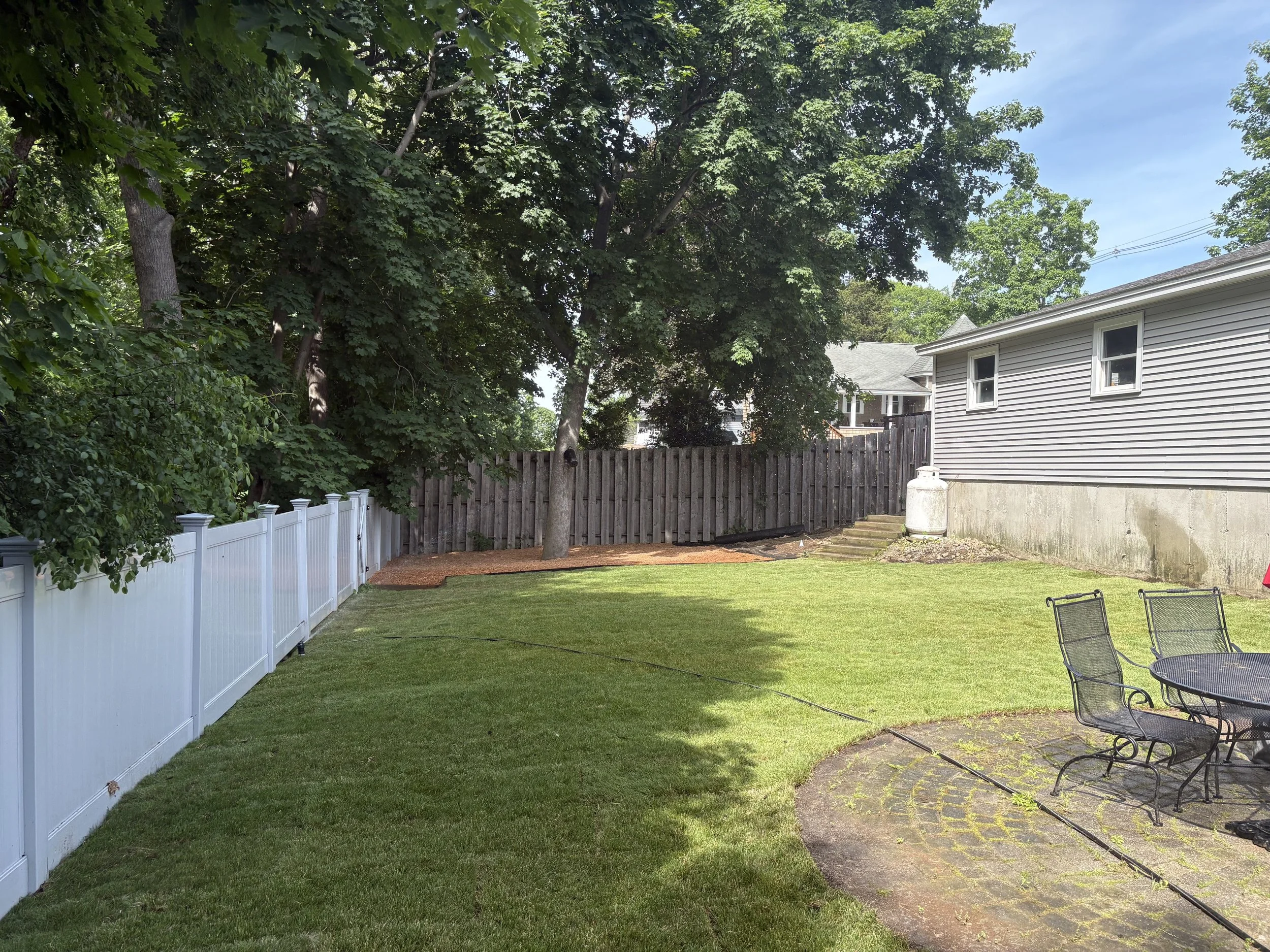 Fresh sod installation and decorative stone create a clean, low-maintenance landscape.