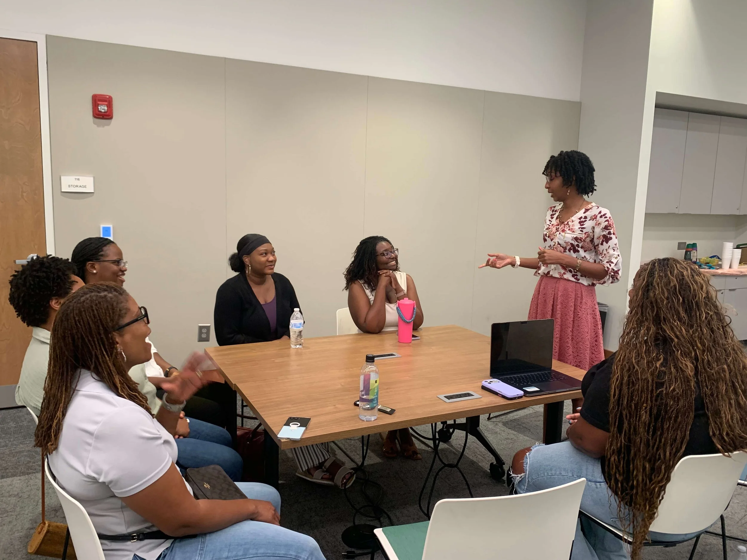 Photo of Meagan Harrison, LCSW – Black ADHD therapist located in Atlanta, GA – leading a wellness workshop with several participants.