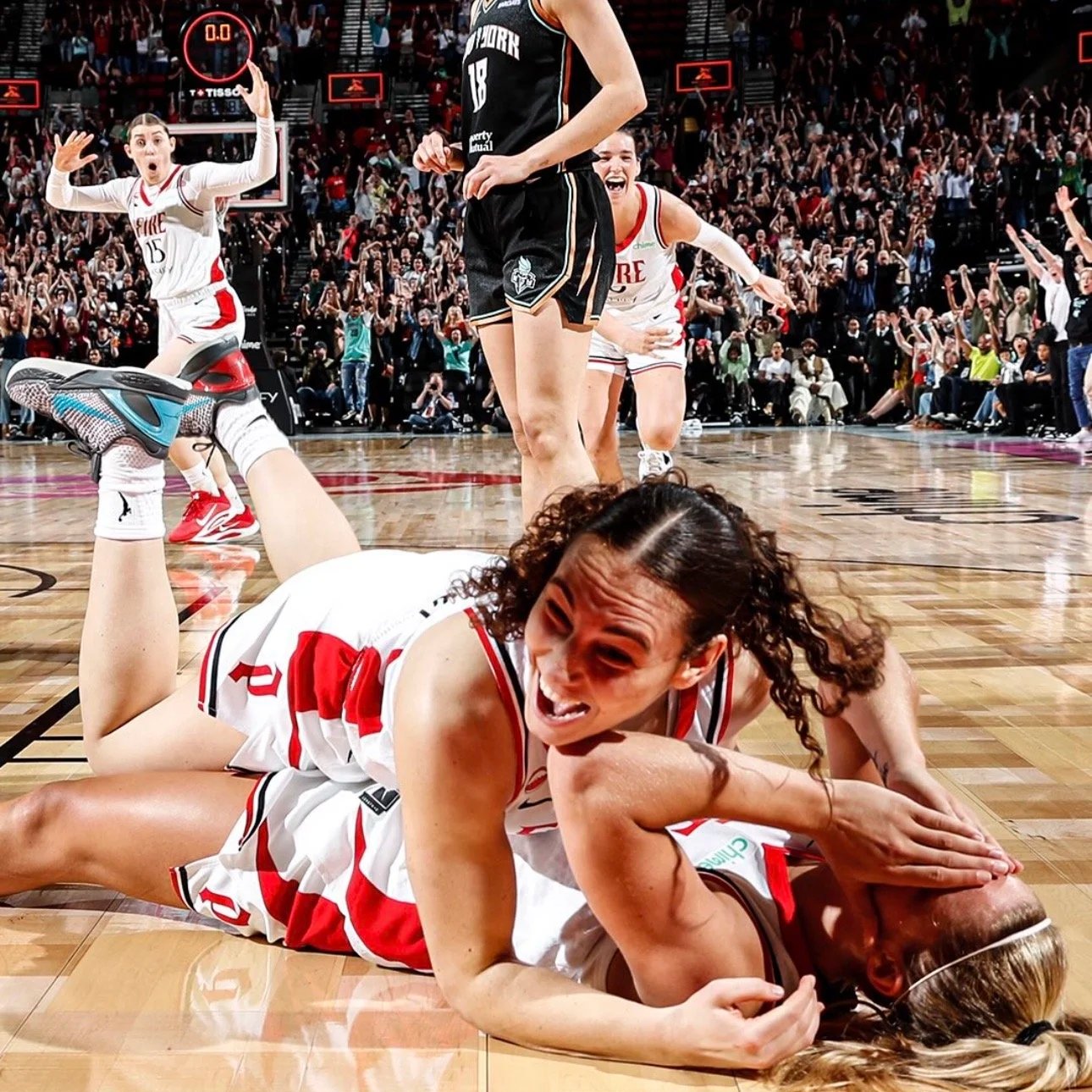 Carla Leite jumps on Sarah Ashlee Barker after hitting the game winning shot.
