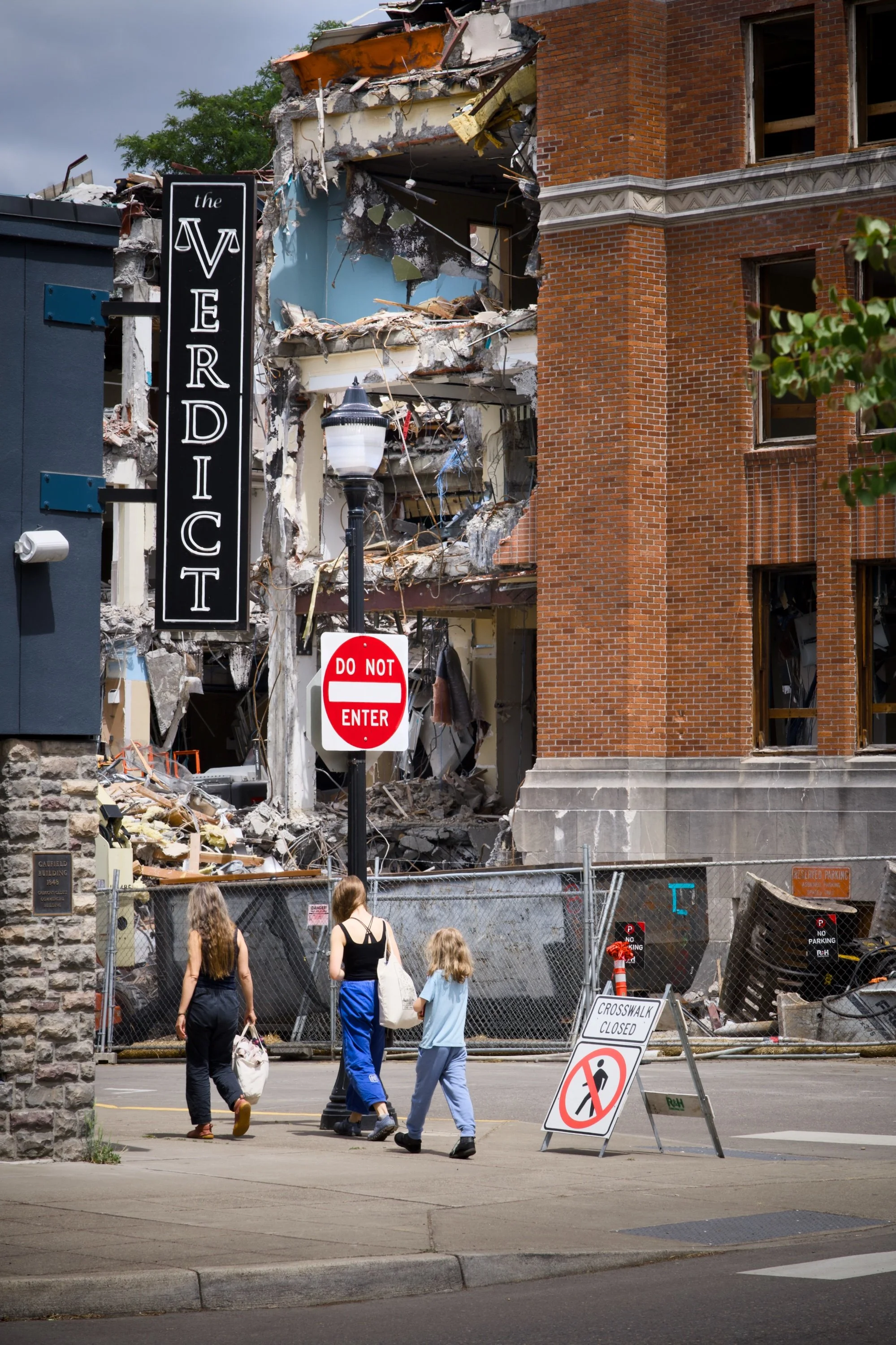 Pedestrians cruise past the demolished courthouse - Oregon City, Oregon.