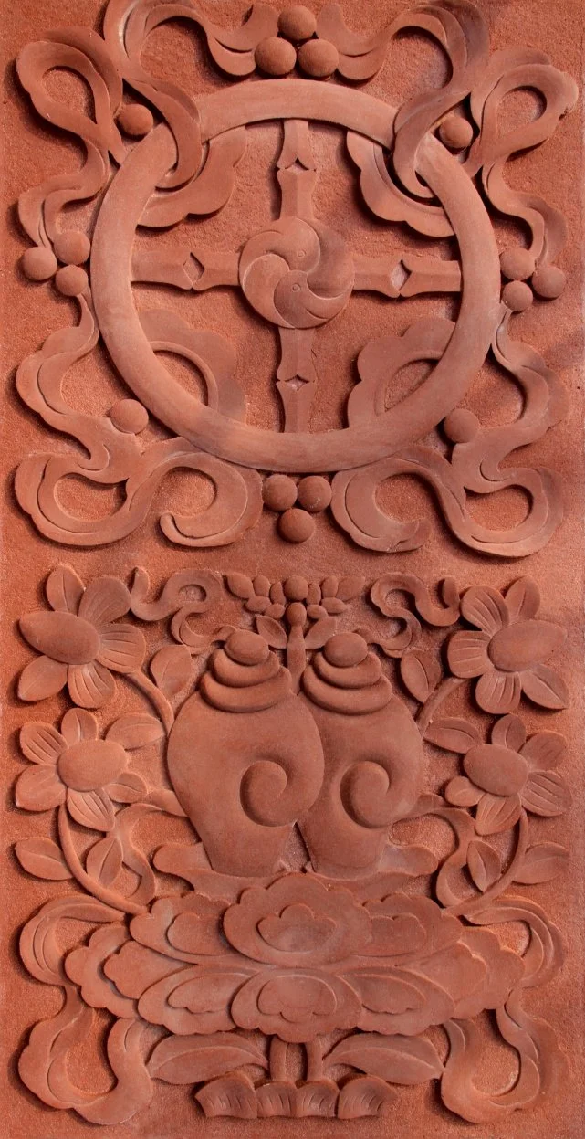 Carved wooden wall art featuring a traditional clock at the top, ornate floral and swirl patterns, two vases with flowers in the center, and decorative cloud and cloud-like patterns at the bottom.