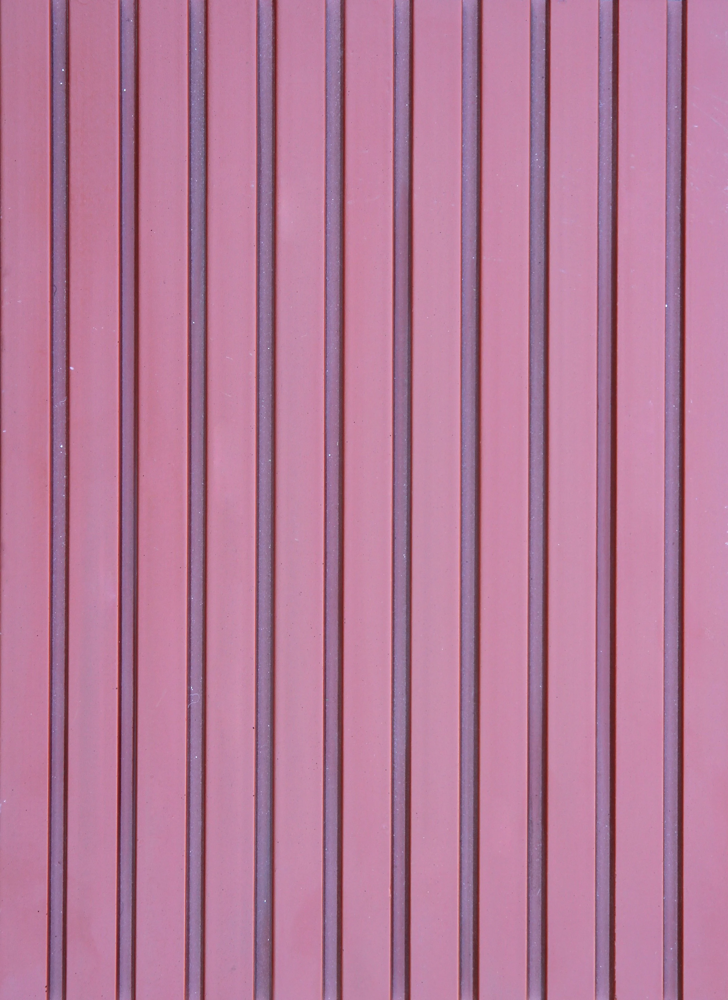 Close-up of vertical brown and pink painted metal slats