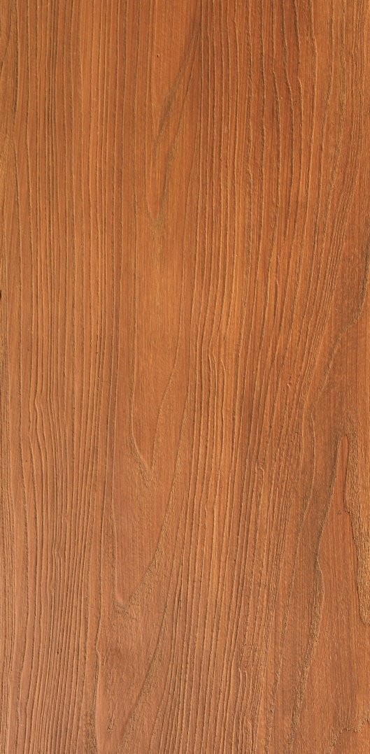 Close-up of a wooden surface with visible grain patterns and a reddish-brown finish.