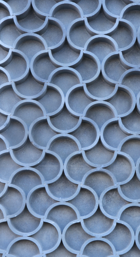 A close-up of repeating circular metal brackets or rings arranged in a pattern.