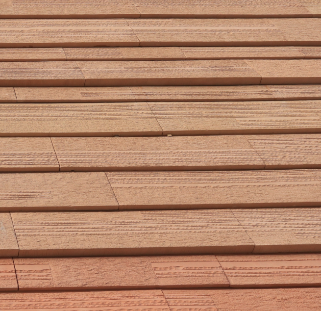 Stacked wooden planks with visible grain and texture.