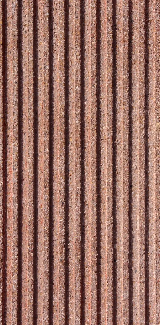 Close-up of a brown brick wall with vertical ridges.