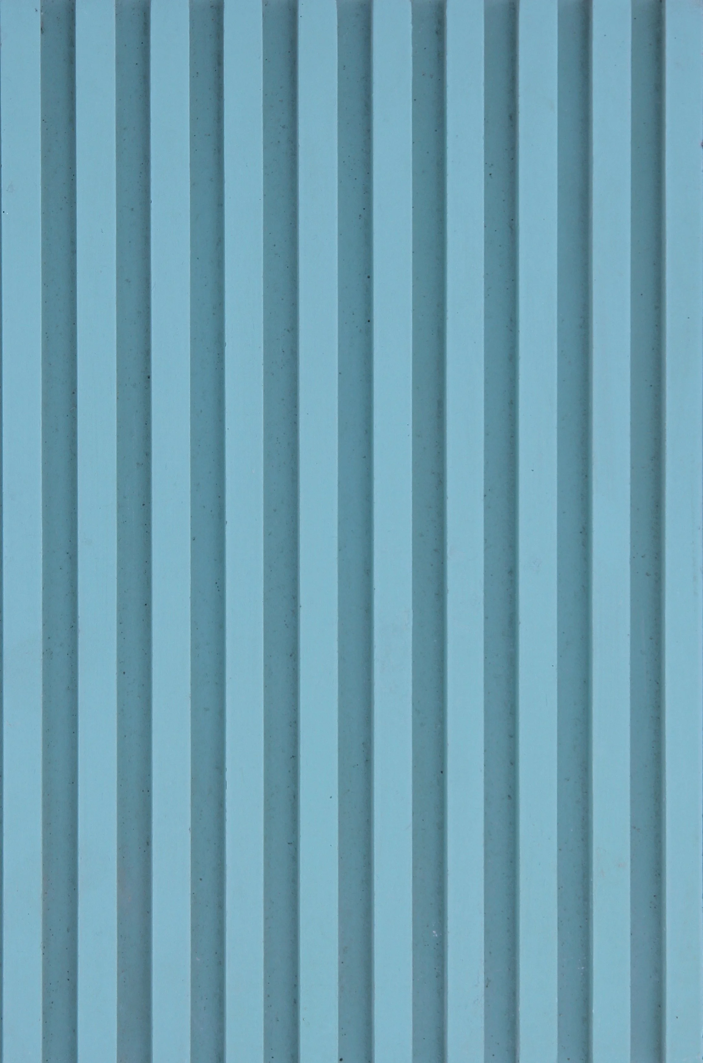 Close-up of a blue metal surface with vertical ridges.