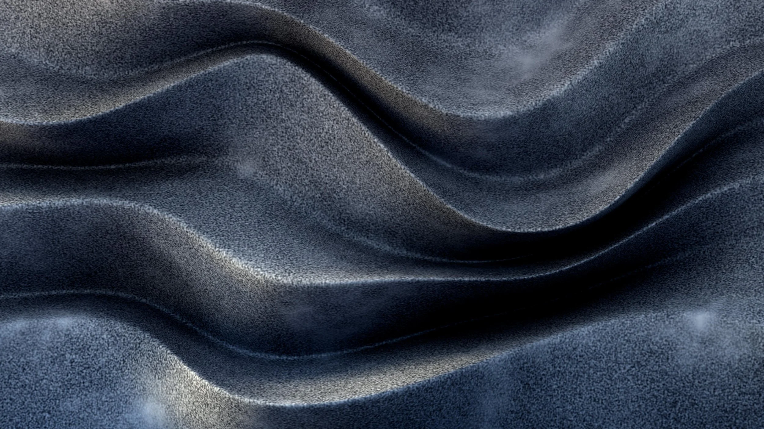 Close-up of a smooth, dark gray fabric with gentle folds and a speckled texture.