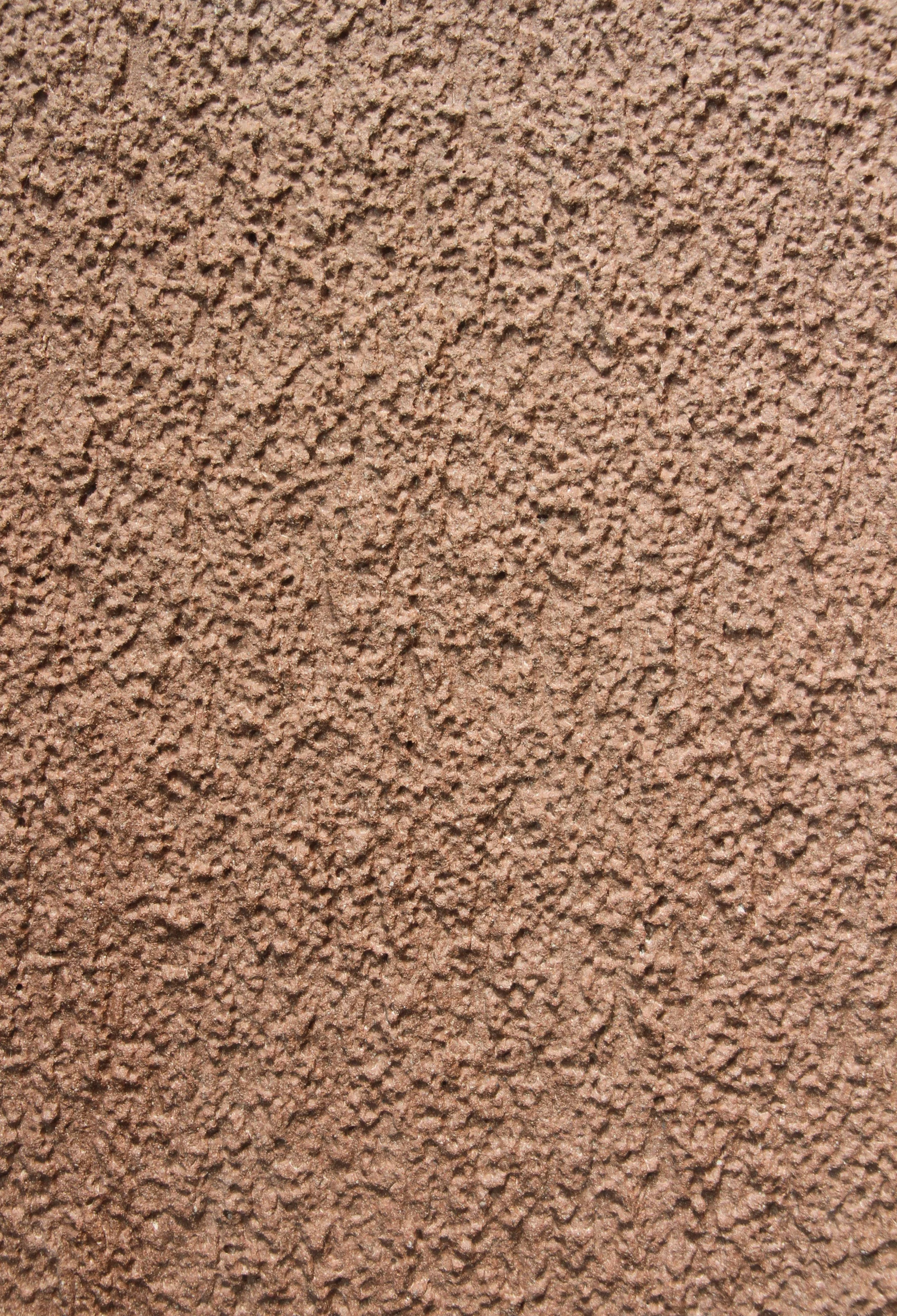 Close-up of a textured beige stucco wall.