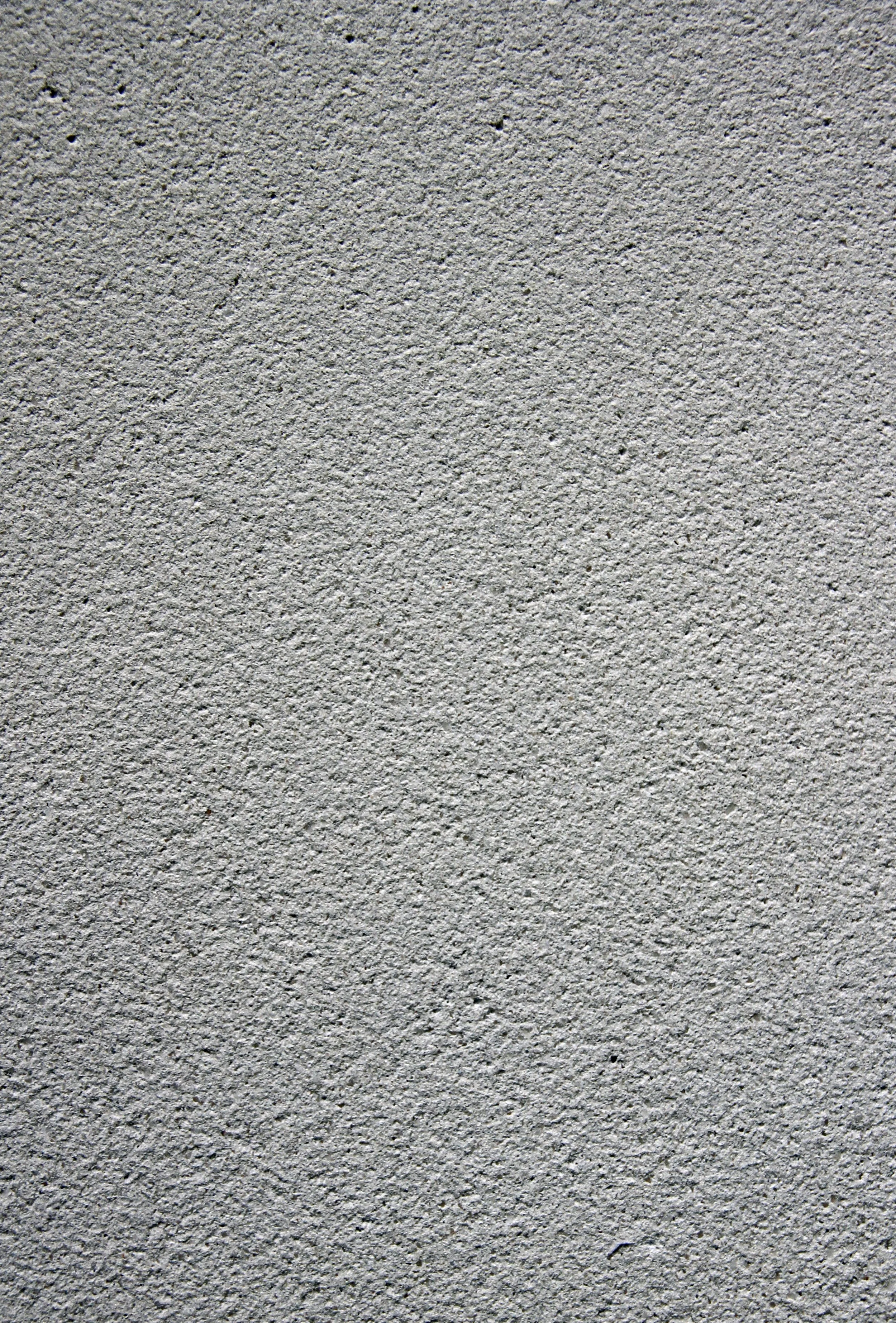 Close-up texture of gray concrete wall with a rough, gritty surface.