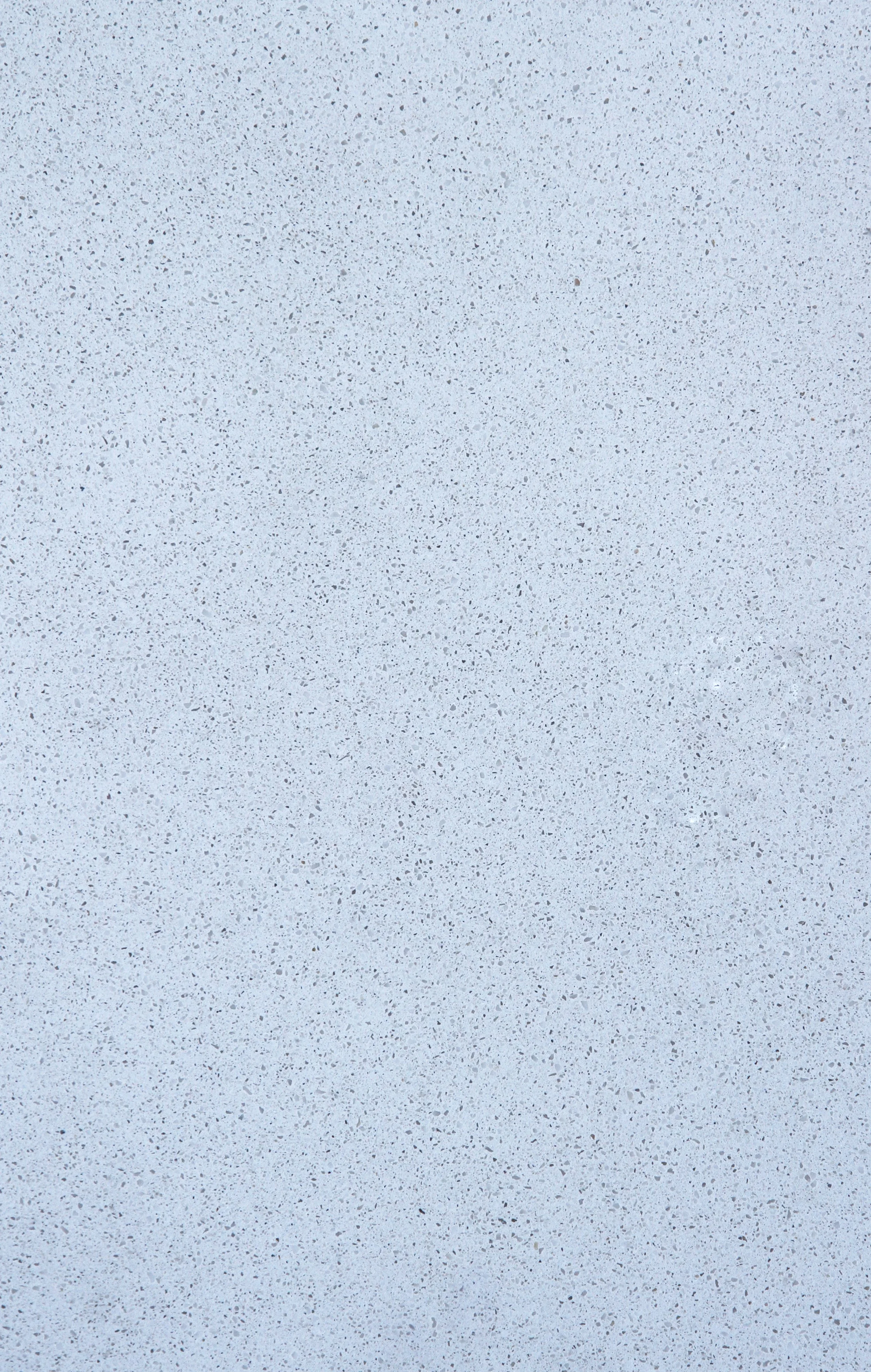 A smooth, speckled grey and white surface, resembling a concrete or terrazzo flooring material.