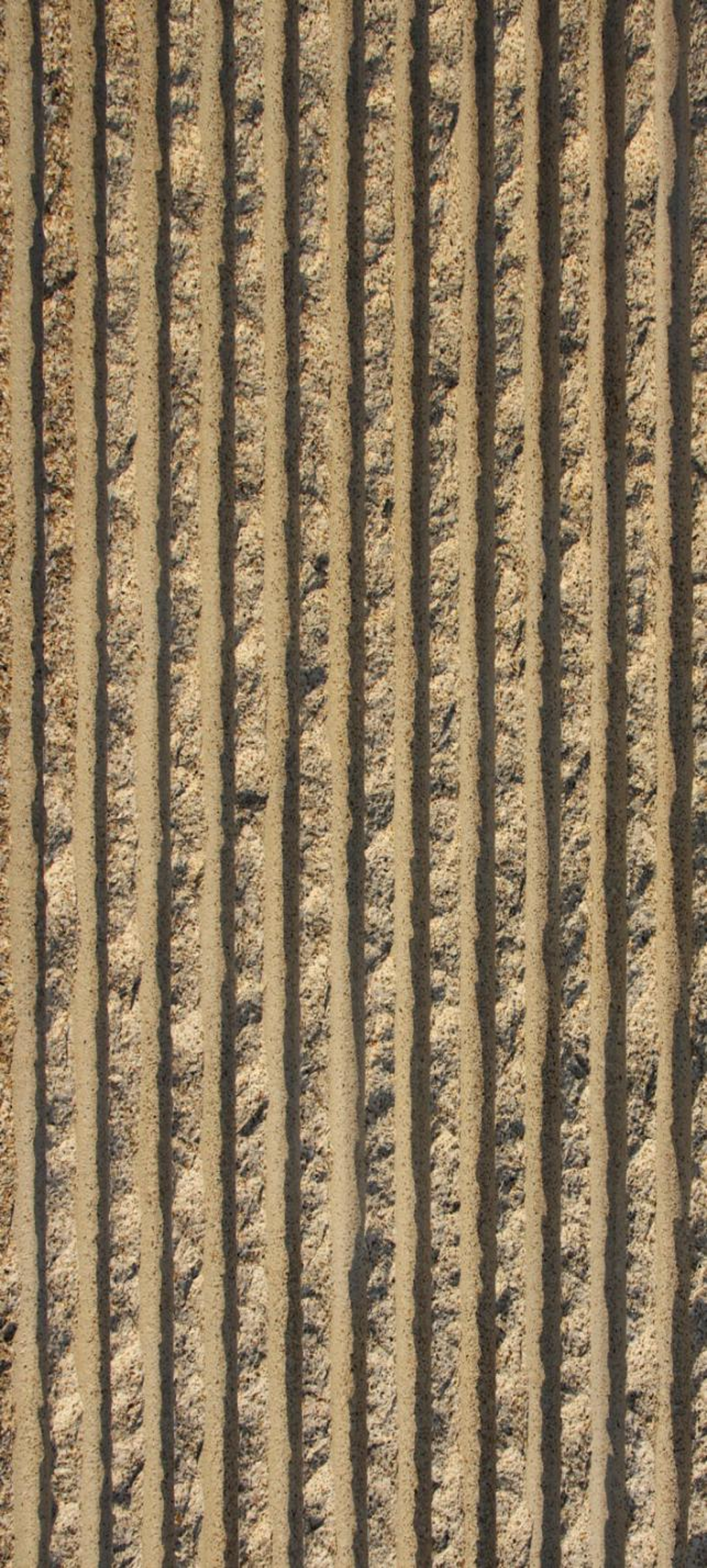 Close-up view of parallel tire tracks in sandy soil.