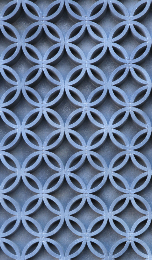 Close-up of a metal grid with interlocking circular patterns.