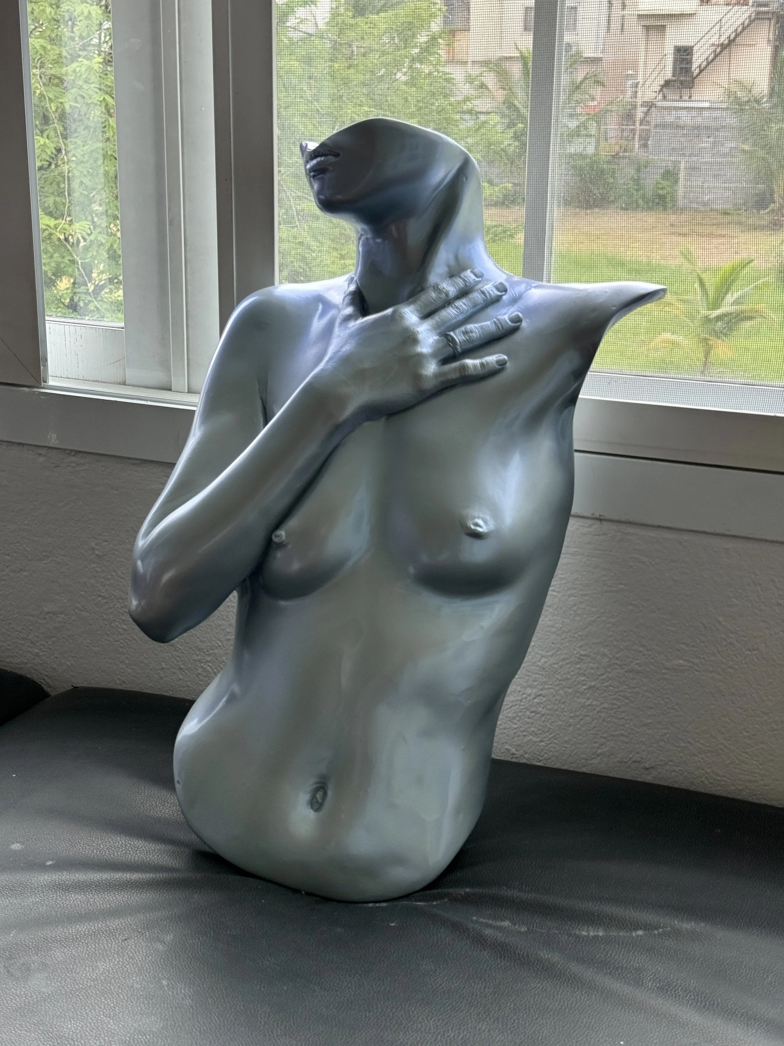 A white sculpture of a woman with four green labels pointing to her mouth, chest, and belly bottom. The text reads 'mouth,' 'posture as this picture,' and 'belly bottom.' The sculpture is in a classical style with detailed hair, minimal clothing, and an outstretched arm.