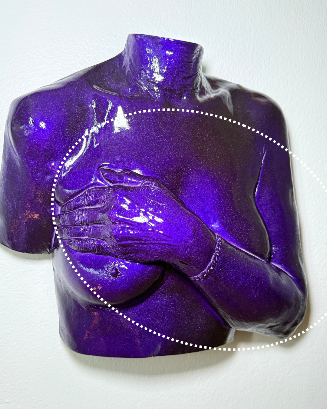 A glossy, purple-colored sculpture of a female torso with a hand covering the chest, wearing a bracelet, against a plain white background.
