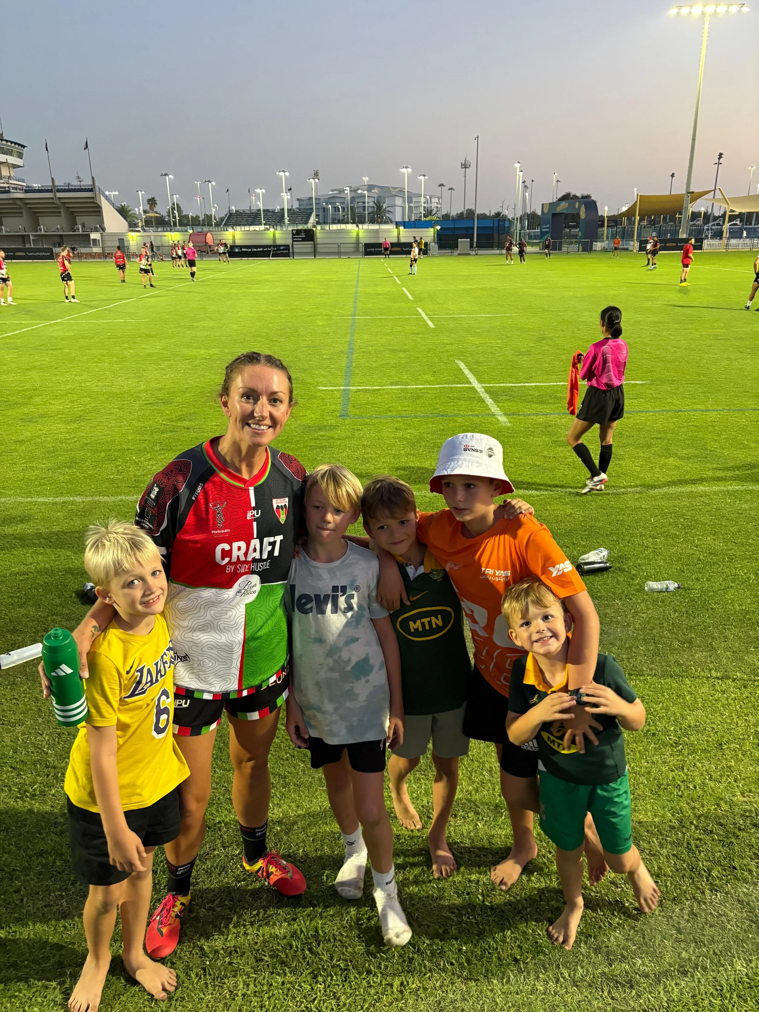 TJ Manson with her five boys on a rugby pitch in Abu Dhabi
