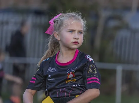 Young Skirlaugh Girls player standing on the pitch.