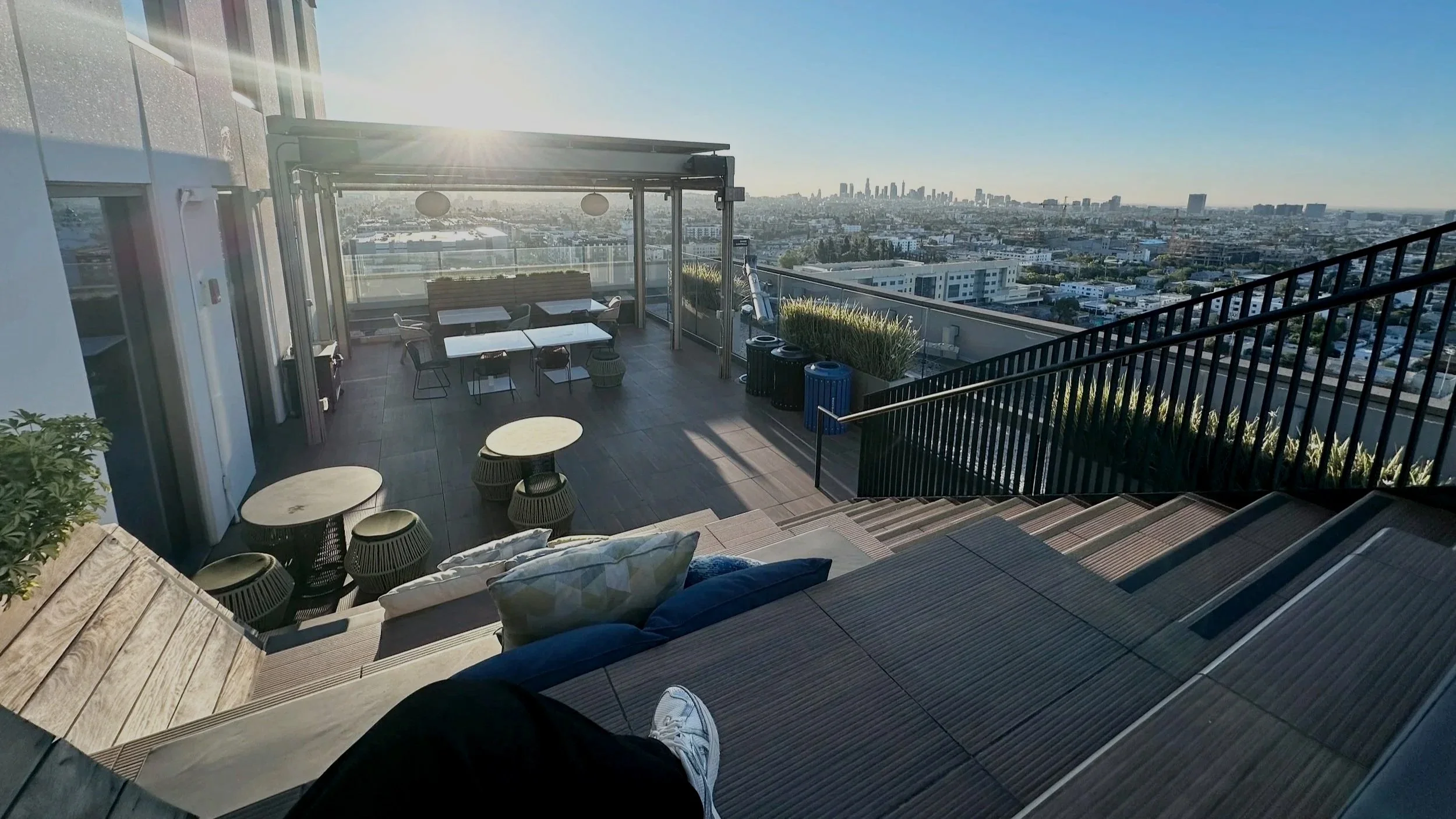 Rooftop overlooking downtown Los Angeles skyline at sunrise.