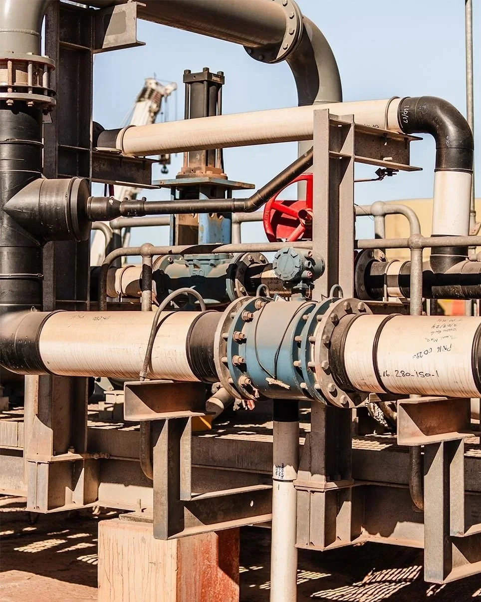 Above-ground HDPE and steel pipe rack with flanged valves and instrumentation at mine site process plant, Western Australia