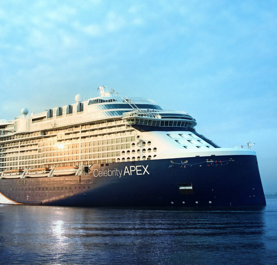 A large cruise ship named Celebrity Apex sailing on calm water with a clear sky in the background.