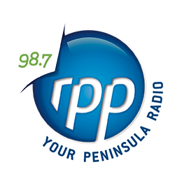 Logo of TPP Radio featuring a blue circular design with white text and a green accent reading 98.7, and the phrase Your Peninsula.