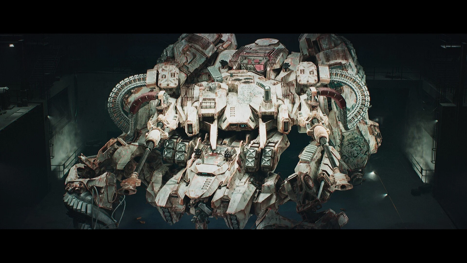 A large, heavily armored robot with multiple weapons in a dark industrial setting.