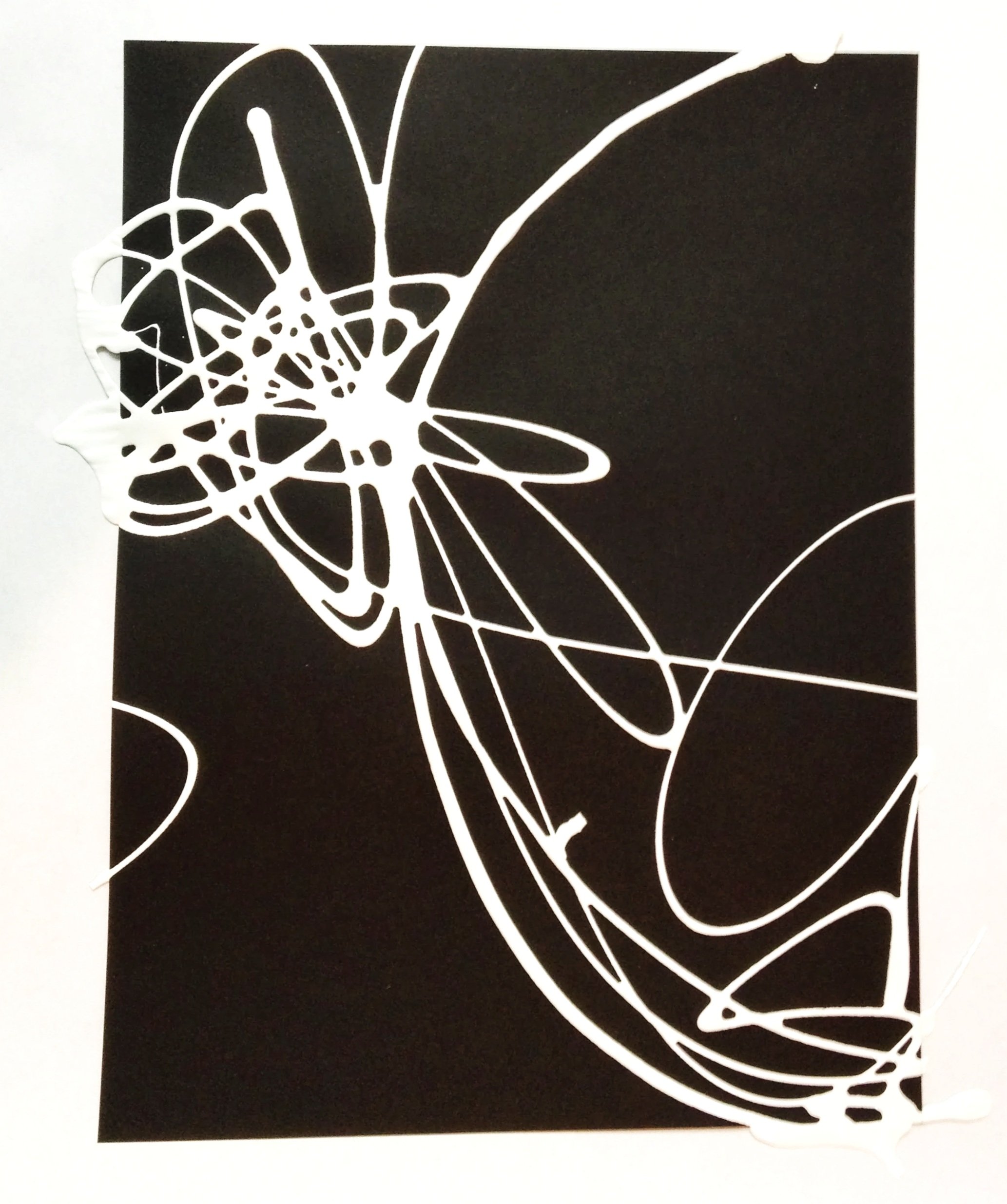 A black and white paper cutout of a butterfly, with intricate wing details, on a white background.