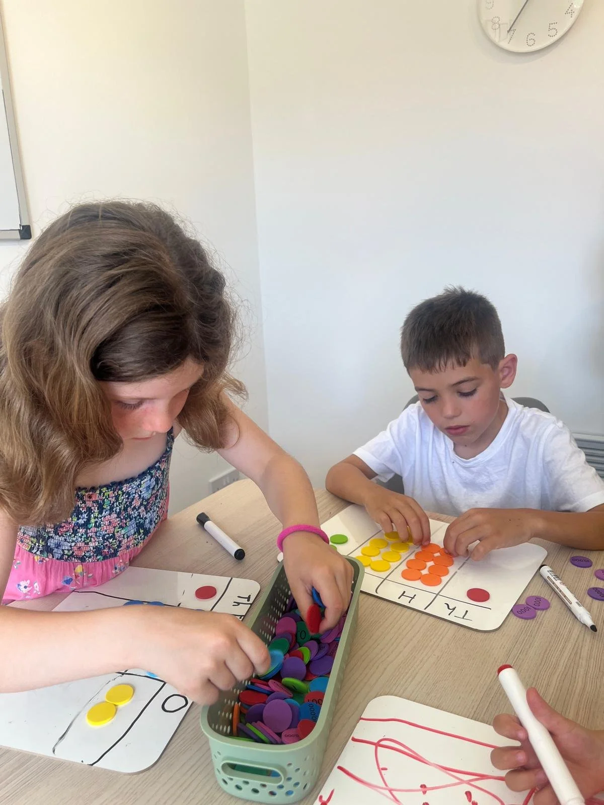 Carrie Perrett working with primary school children during a hands-on maths learning activity in Ampthill.