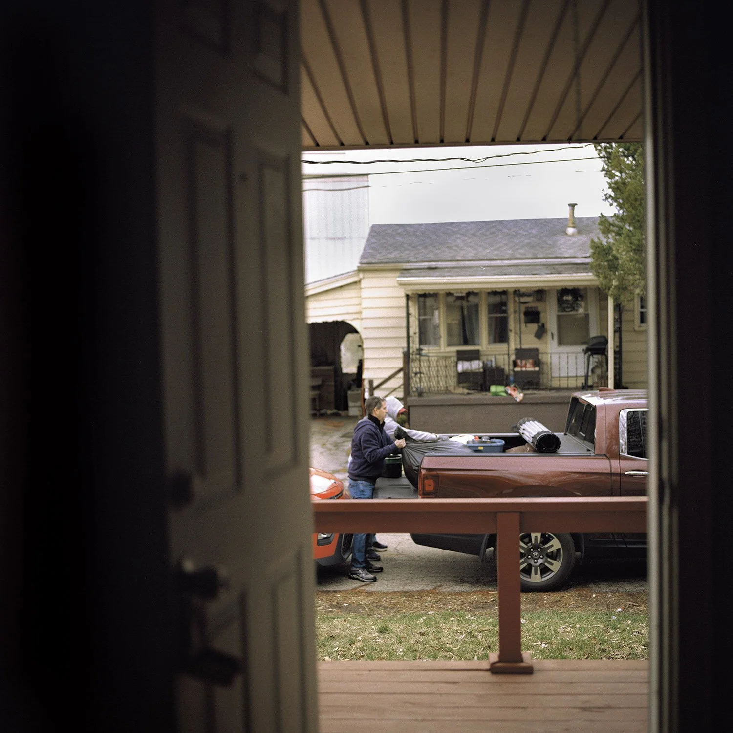 Volunteers moving the donations and the family’s  belongings into the house
