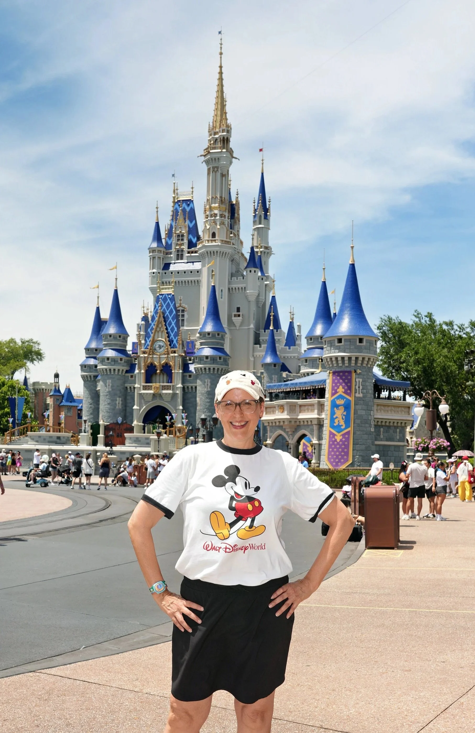Susan Cook in Mickey Mouse Shirt in front of the castle at magic kingdom in Walt Disney World