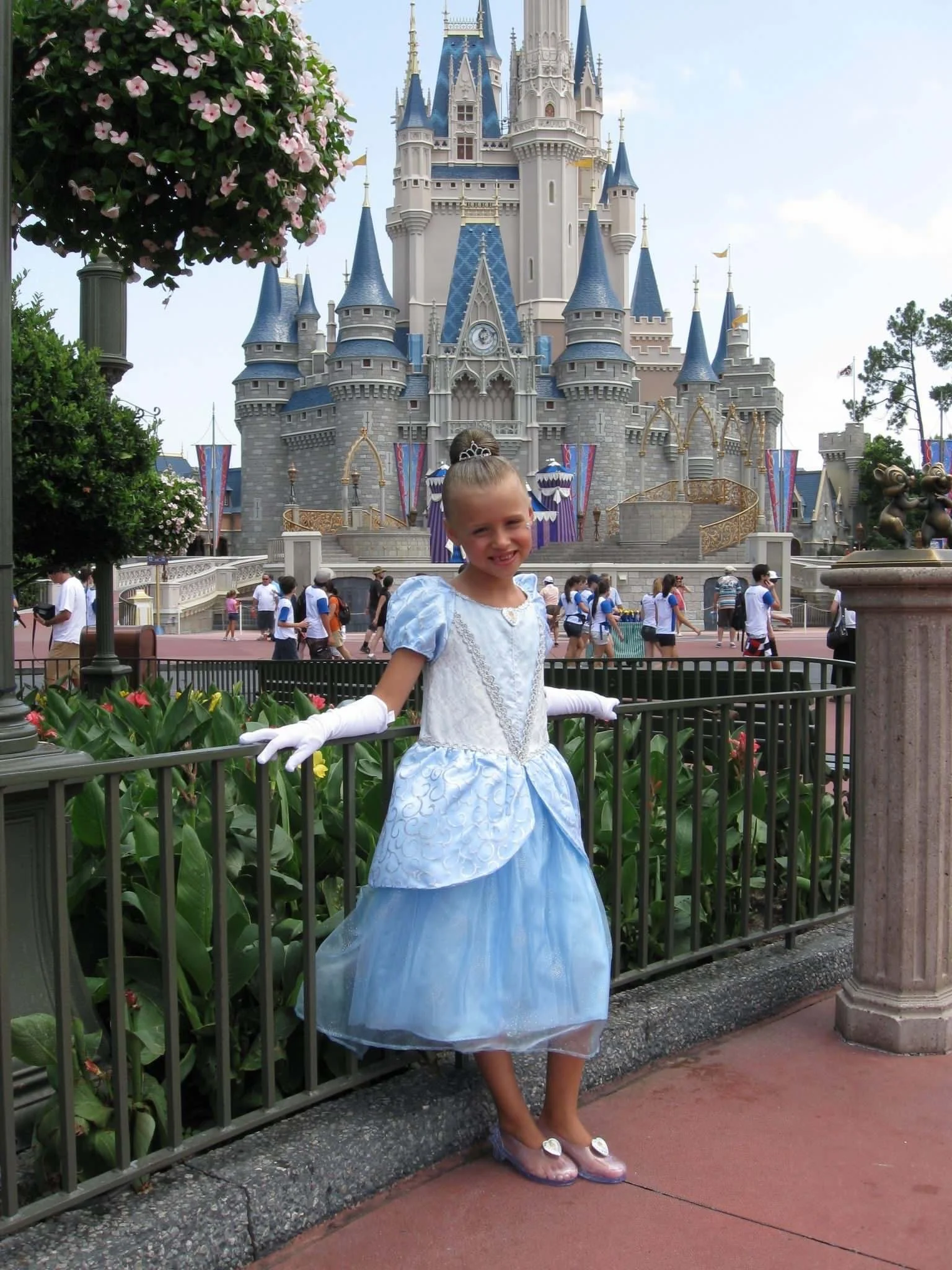 young girl girl dressed up as Cinderella standing in front of the castle at Magic Kingdom, Walt Disney World