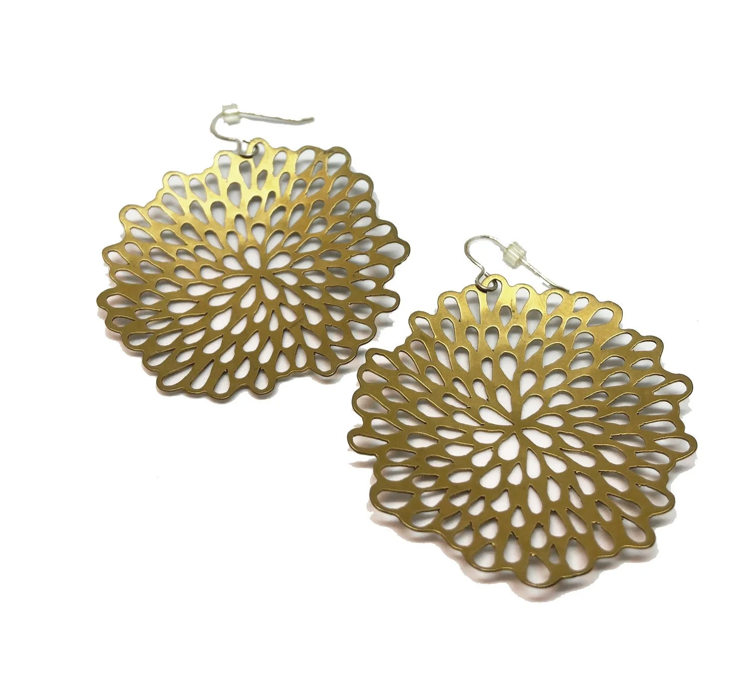 Golden dangle earrings with an intricate floral design on a white background.