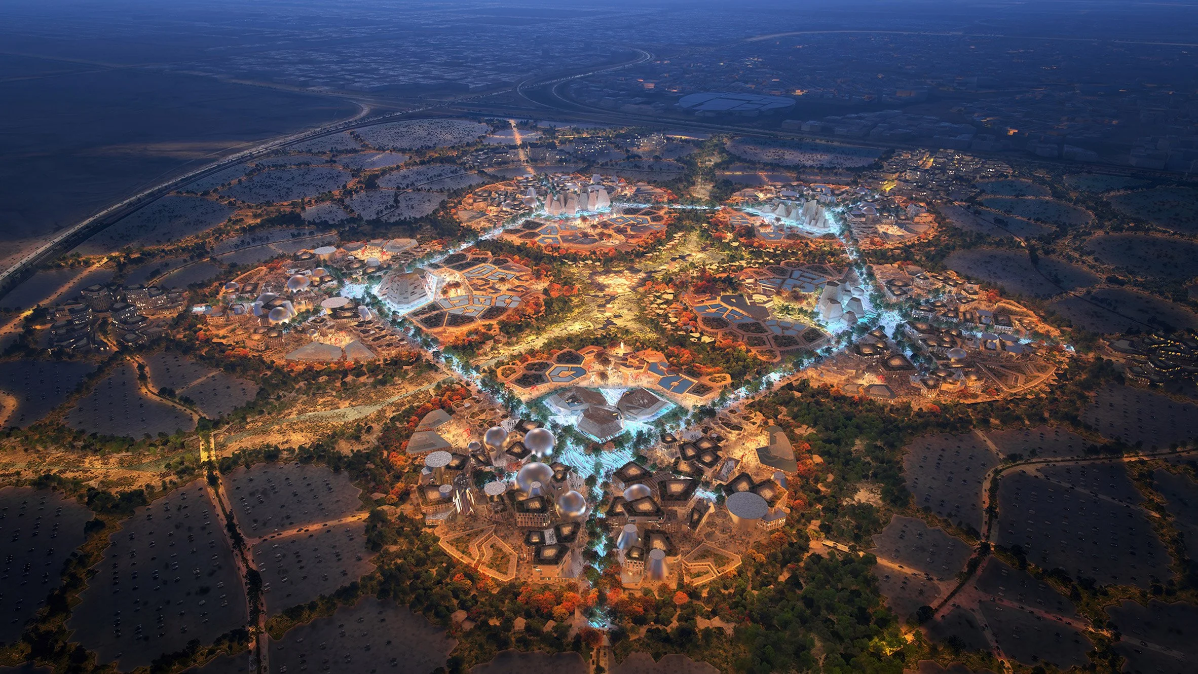 Vue aérienne d'une ville futuriste illuminée la nuit avec des bâtiments aux formes géométriques innovantes et des espaces verts.