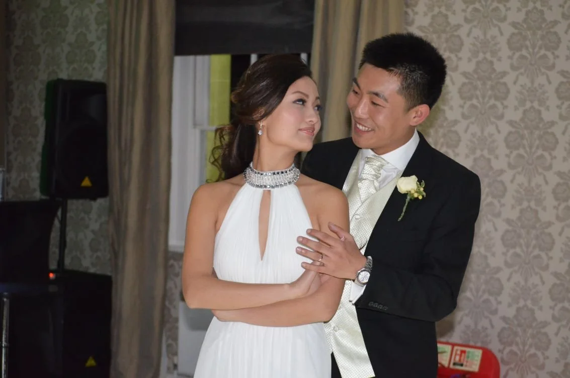A bride and groom sharing a moment, looking into each other's eyes during their wedding dance.
