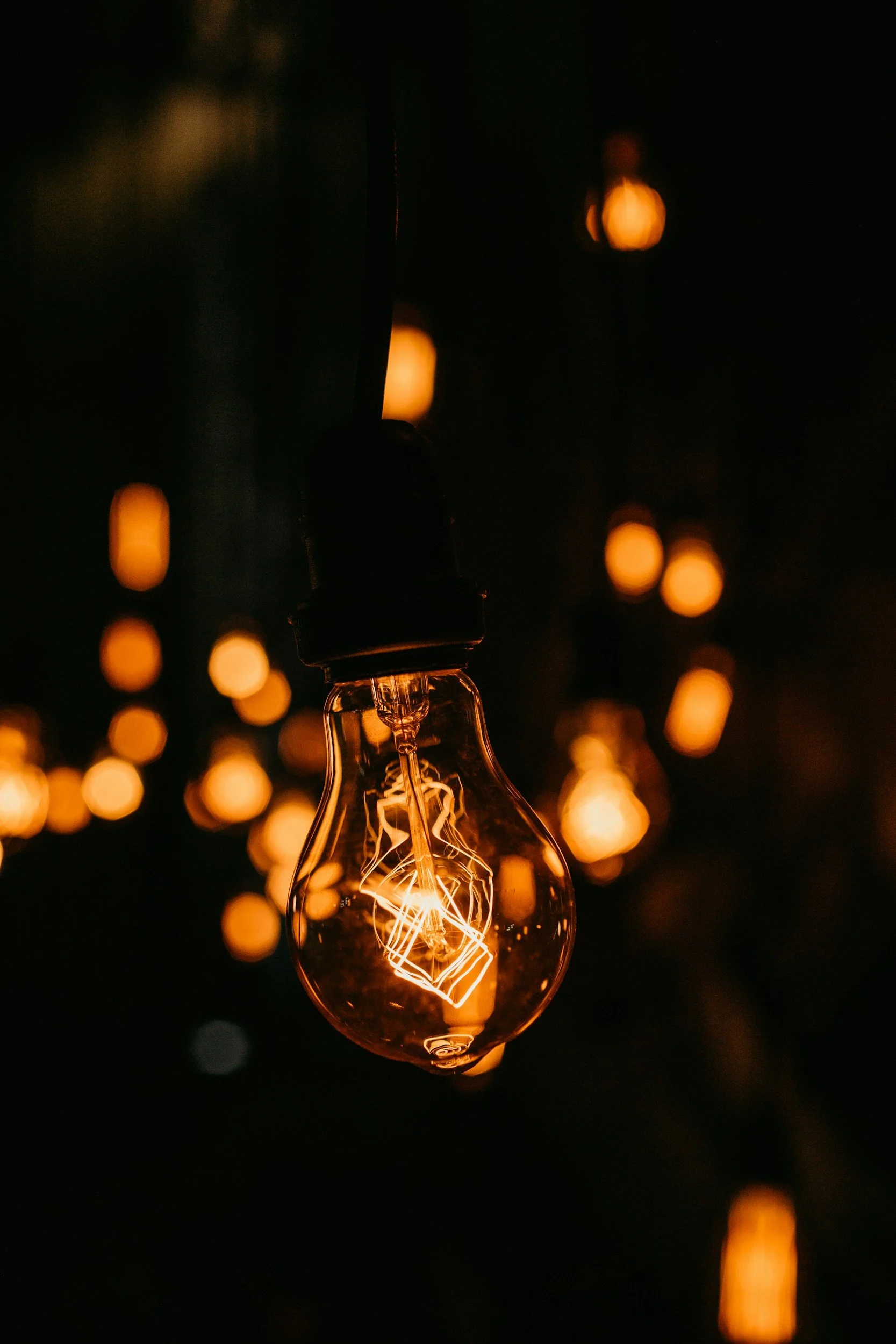 Photo of a glowing lightbulb with a dark background