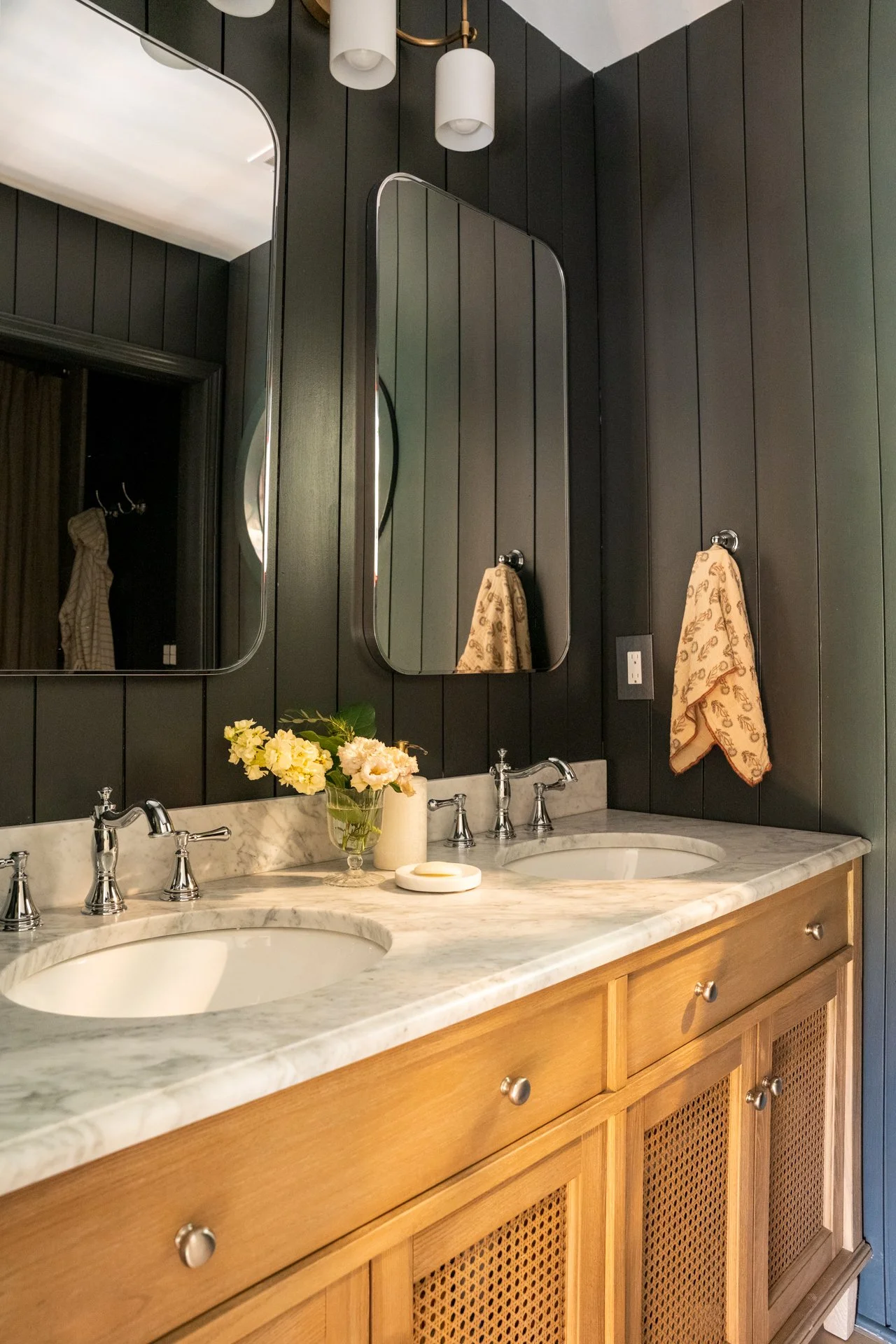 Upstairs bathroom with marble vanity and architectural paneling in Highlands NC