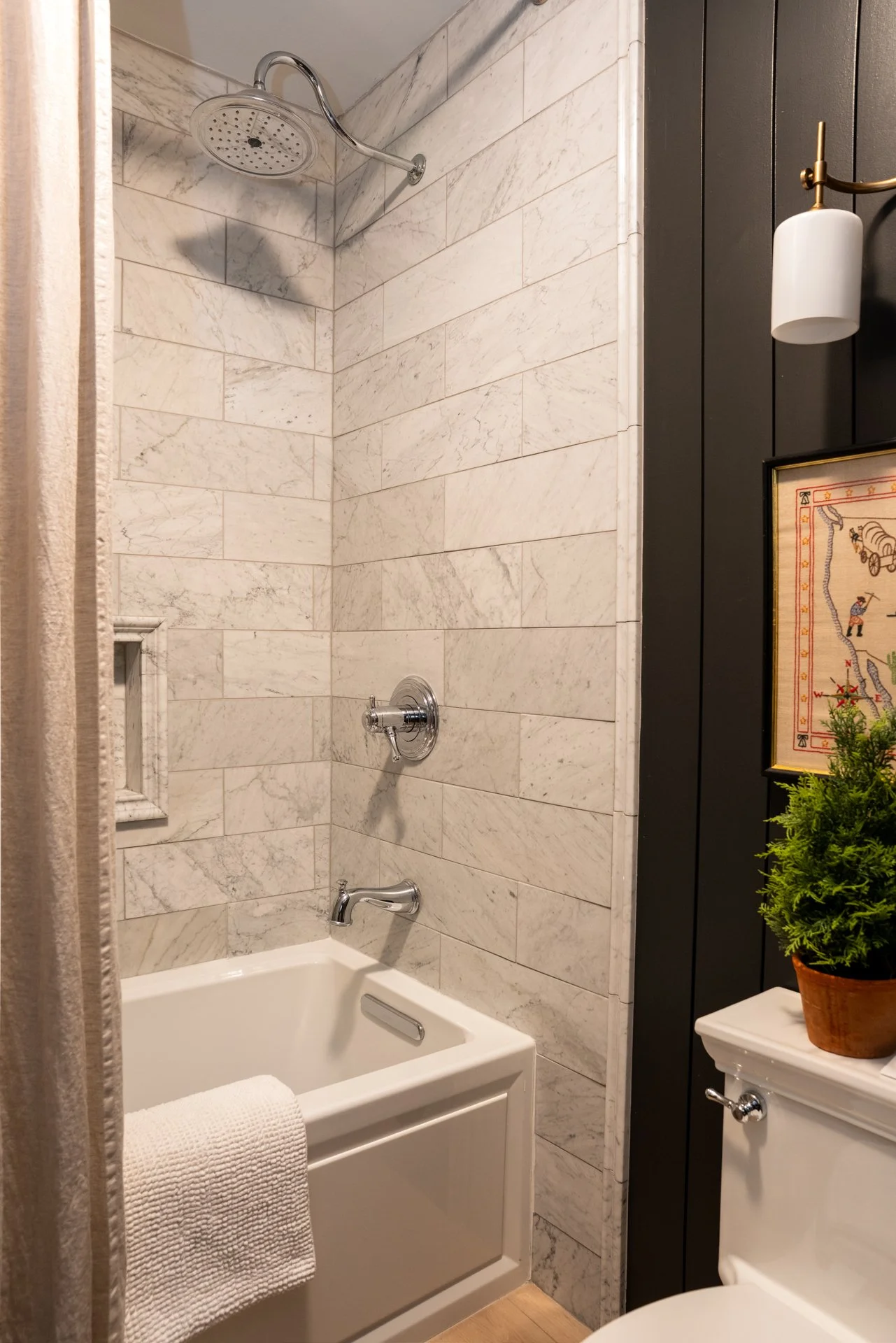 Mountain home bathroom with cohesive natural stone finishes and soft lighting