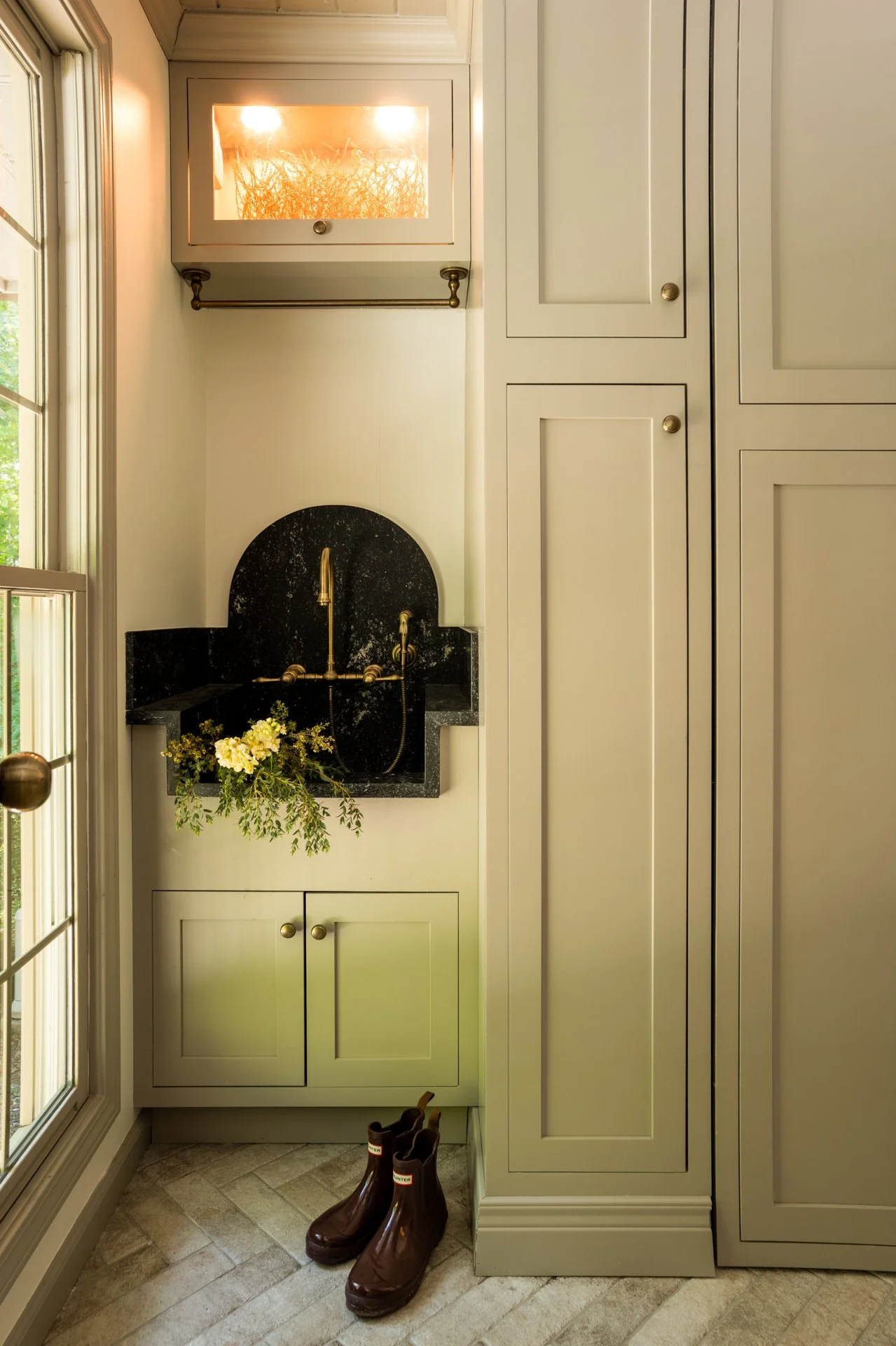 Highlands NC laundry mudroom with concealed millwork and durable stone flooring