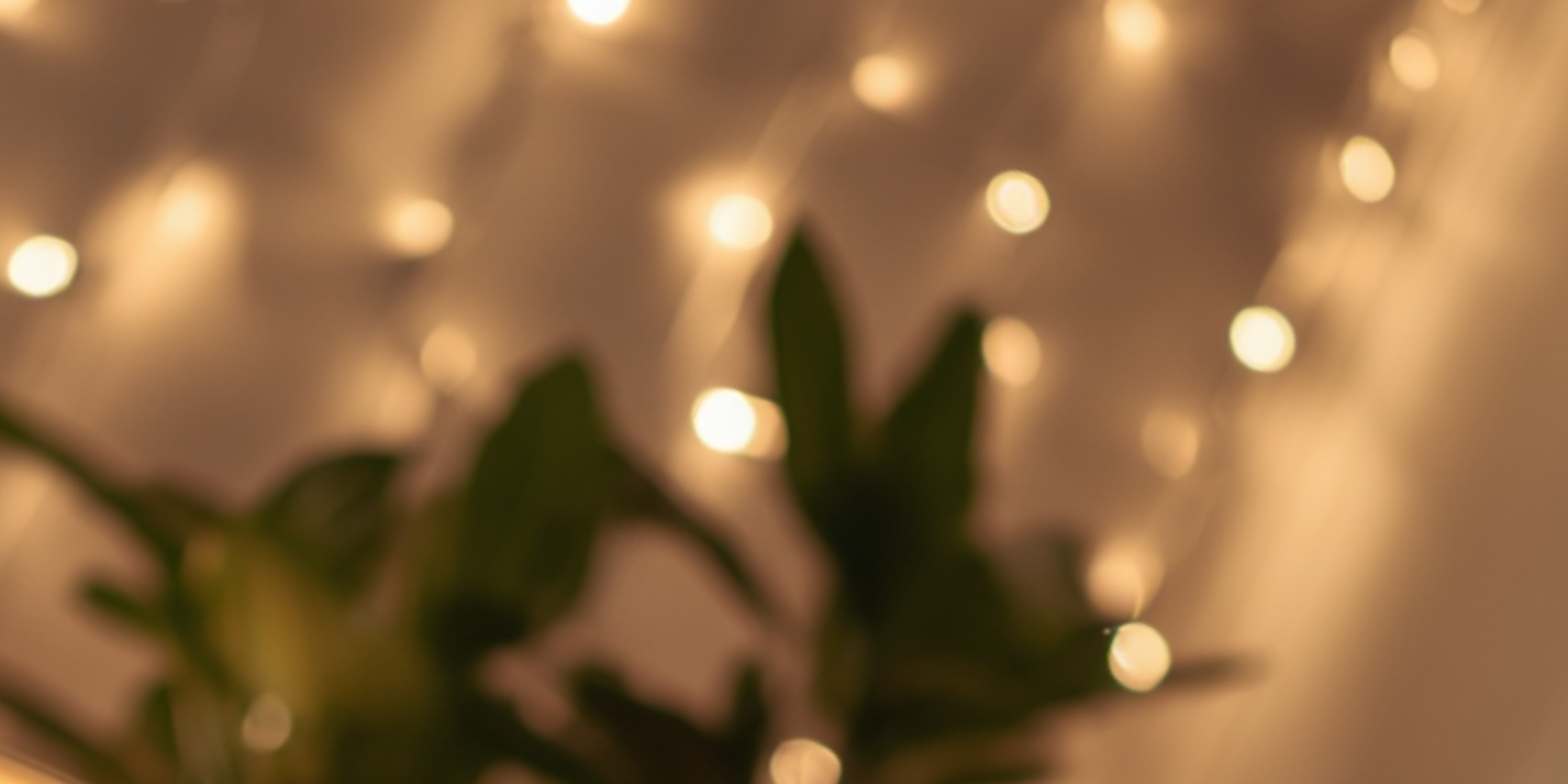 Blurry image of green leaves with soft glowing string lights in the background.