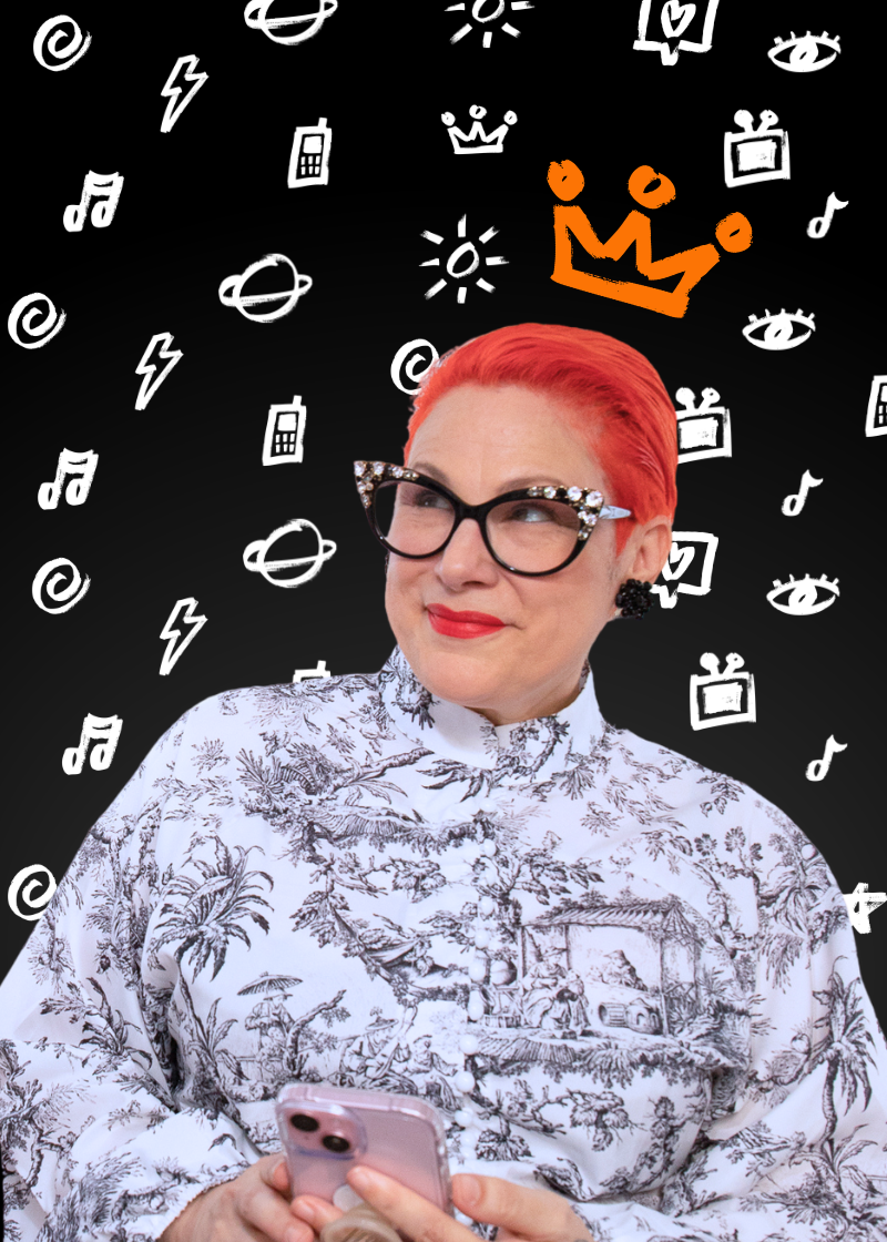 Woman with bright red hair and glasses holding a smartphone, with a black background decorated with white doodles of icons like crowns, eyes, suns, and planets, and an orange crown icon.