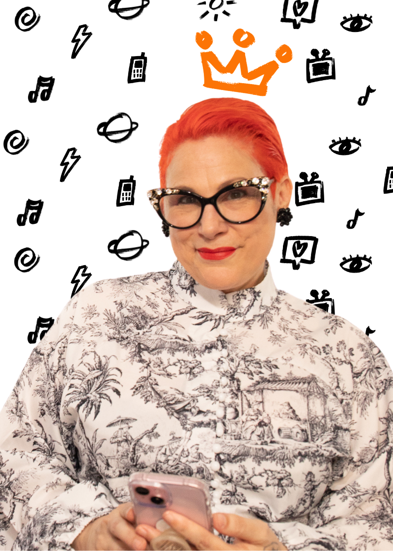 A woman with bright orange hair and black glasses is holding a smartphone, smiling. She is wearing a button-up shirt with a black-and-white landscape pattern. The background has black doodles of various icons, including a crown, eyes, TV, lightning bolt, and music notes, with an orange crown above her head.