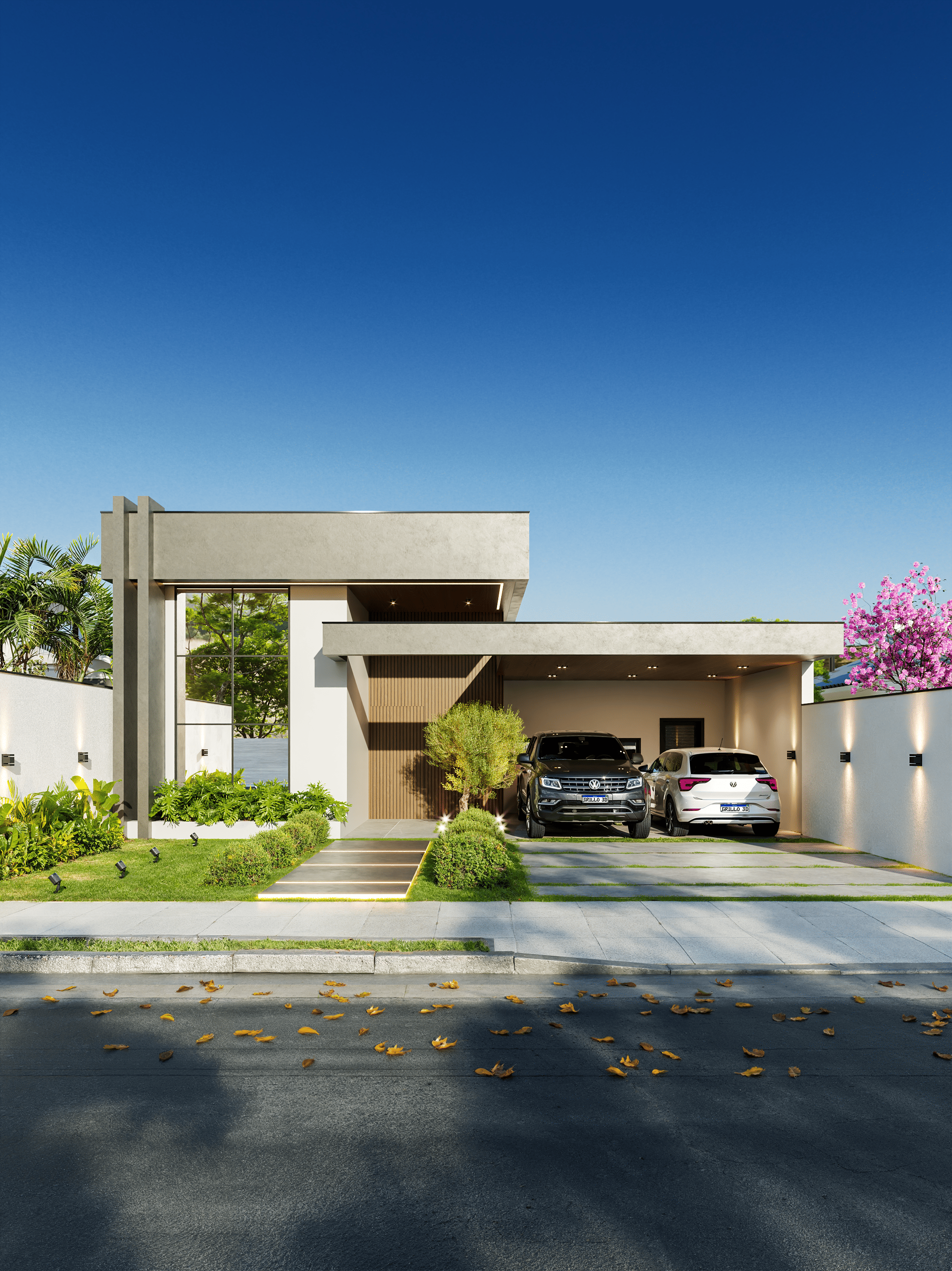 Fachada de uma casa moderna com jardim bem cuidado, duas vagas de garagem com carros, calçada com folhas secas, árvores e plantas ao redor, sobre o céu azul claro.