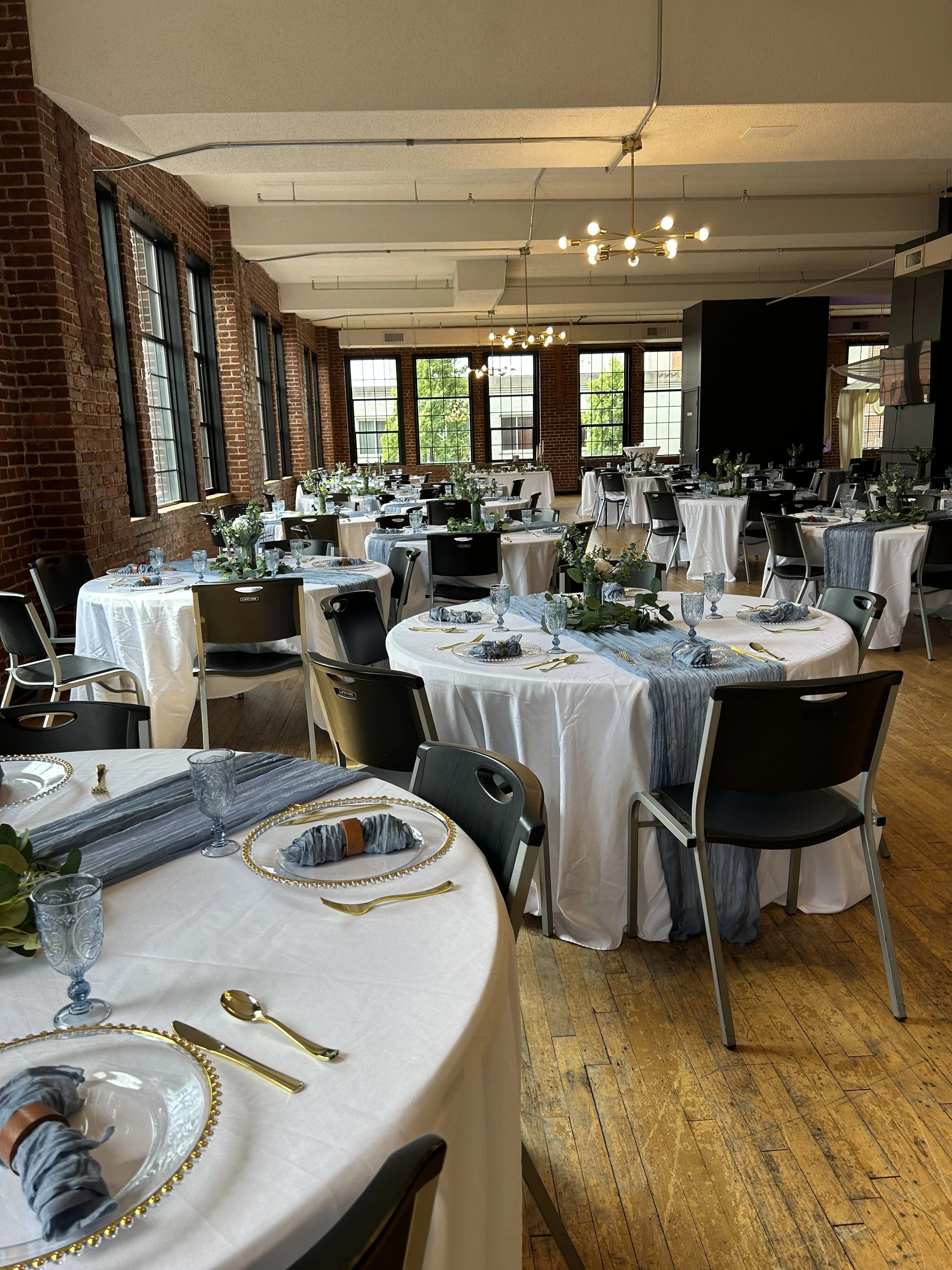Wedding reception with exposed brick and gold accents, day-of coordination by Well Gathered in the Asheville and Johnson City area