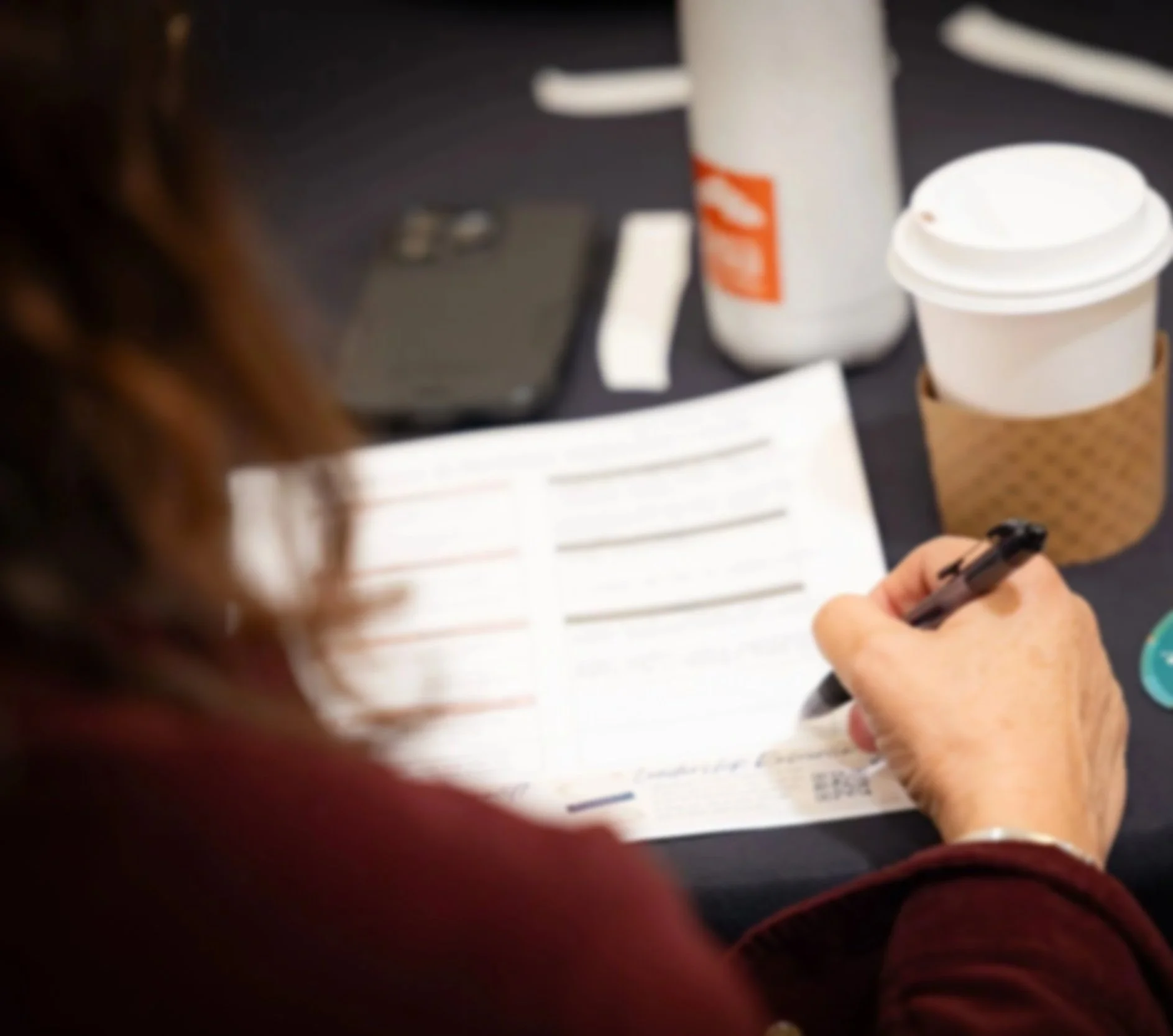 Participants writing during Weaving Wisdom strategic storytelling workshop