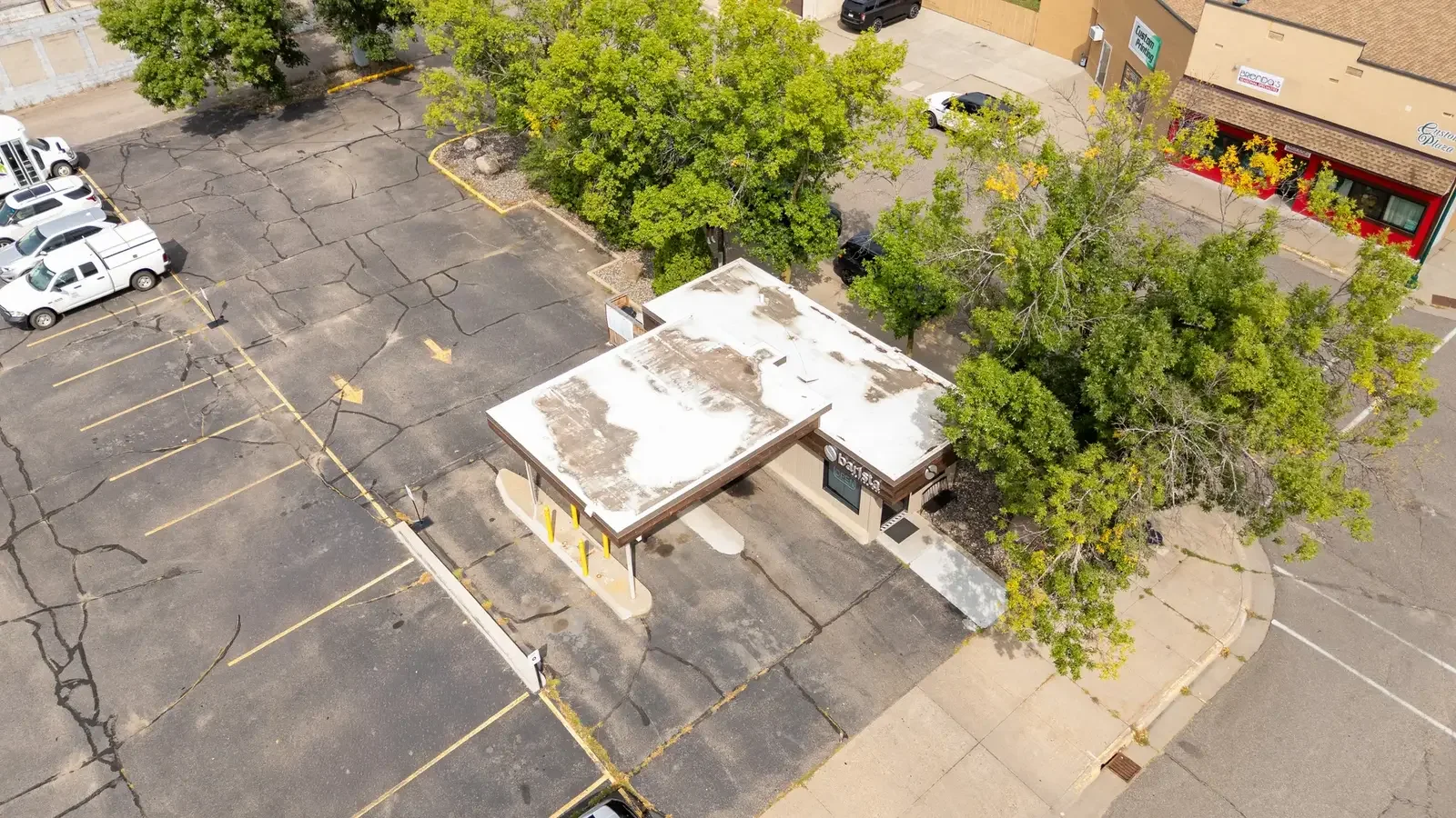 Aerial view of a local coffee shop's drive-through, patio and storefront