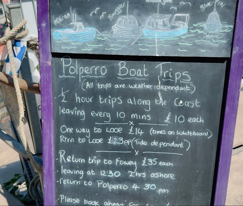 A board with some information on prices for the boat tours from Polperro